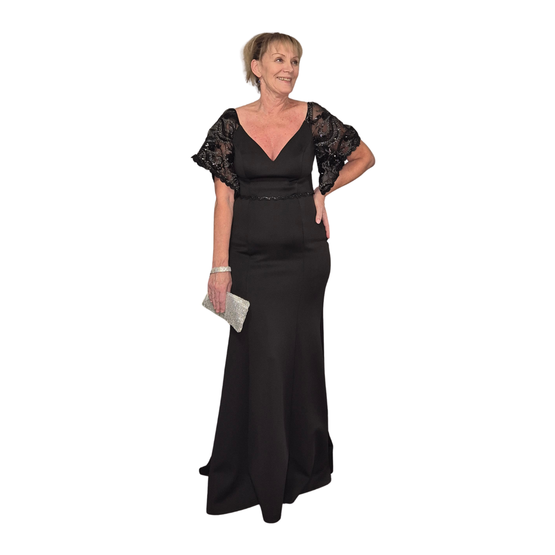 Wendy wearing our absolutely stunning Morticia inspired gown. Gorgeous neckline with beading feature around the waist. A beautiful butterfly arm with embellishment. Zip up back.