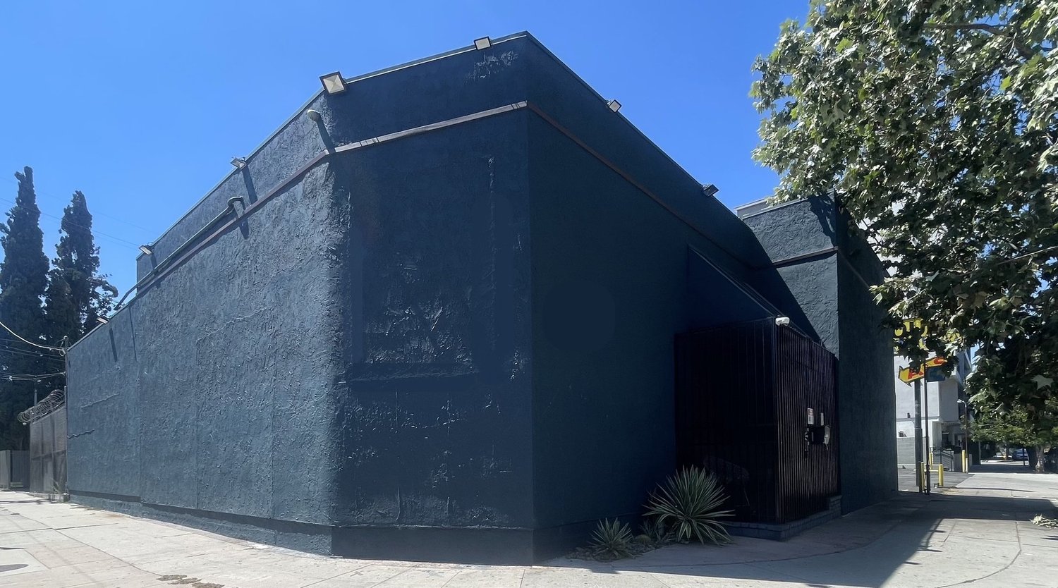 Discreet commercial building exterior illustrating the importance of site and access for a recording facility.