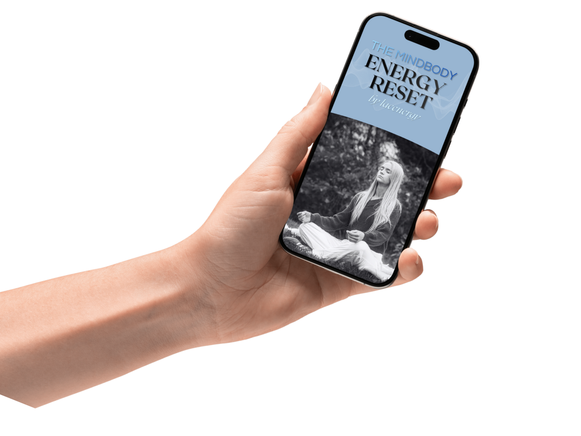 A person holding a smartphone displaying a webpage titled 'The Mindbody Energy Reset' with a black-and-white photo of a woman meditating outdoors.