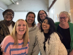 Members of the Perinatal Academy team grouped together and smiling at the camera