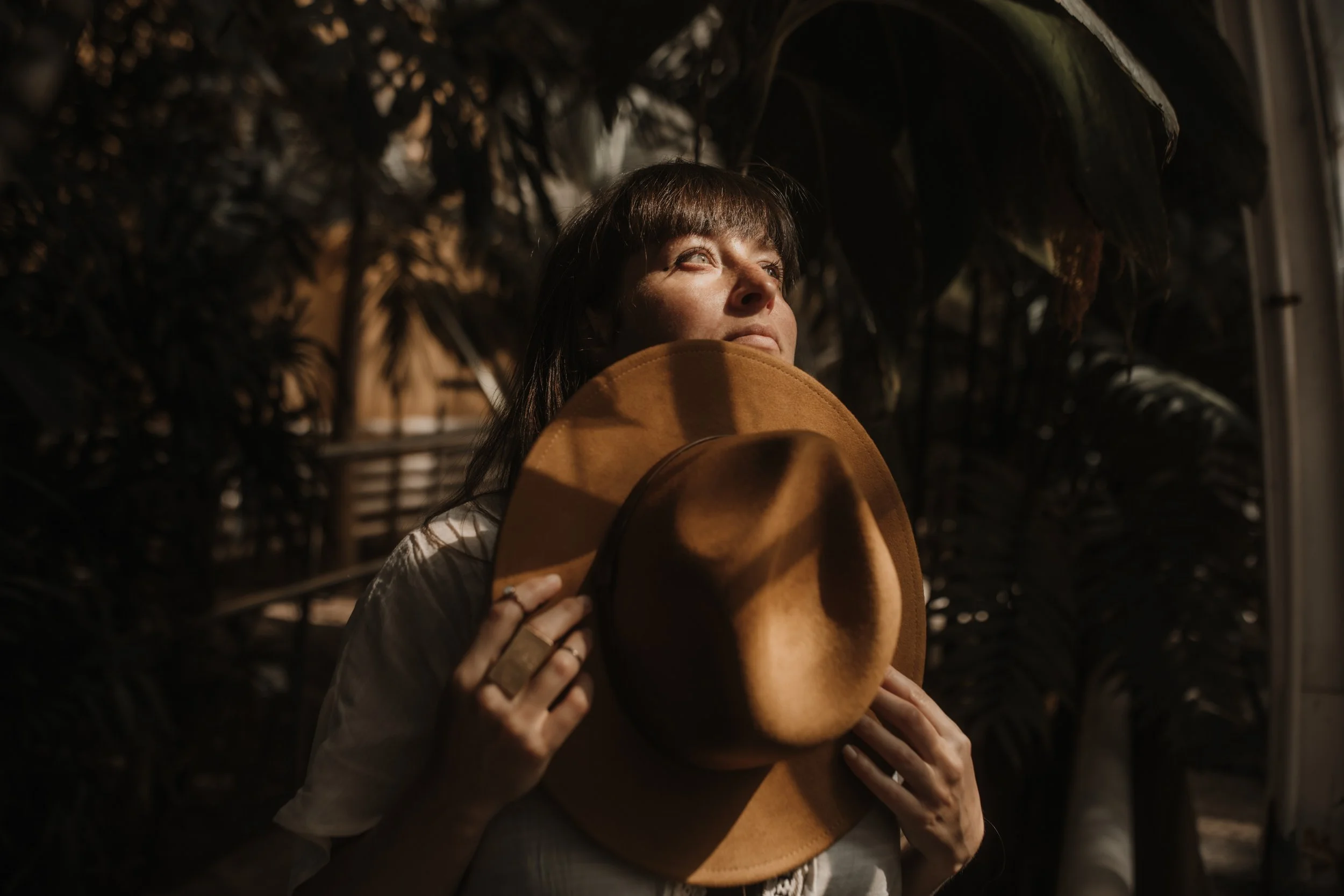 botanical background, woman with golden brown hat