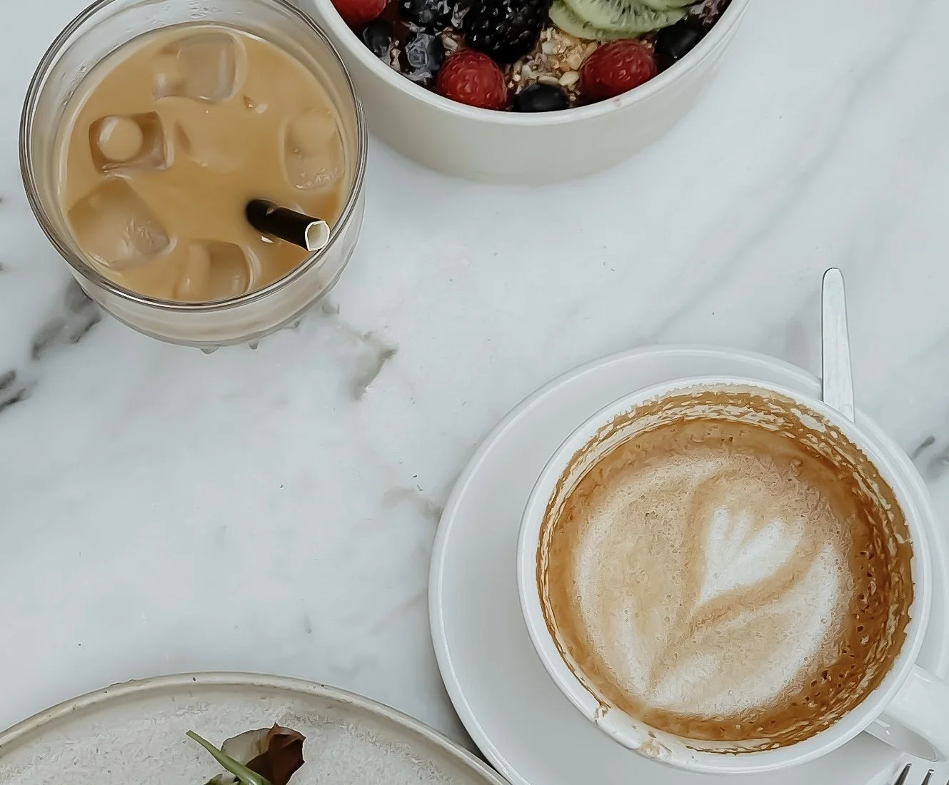 Brunch spread with latte, iced coffee, acai bowl and toast
