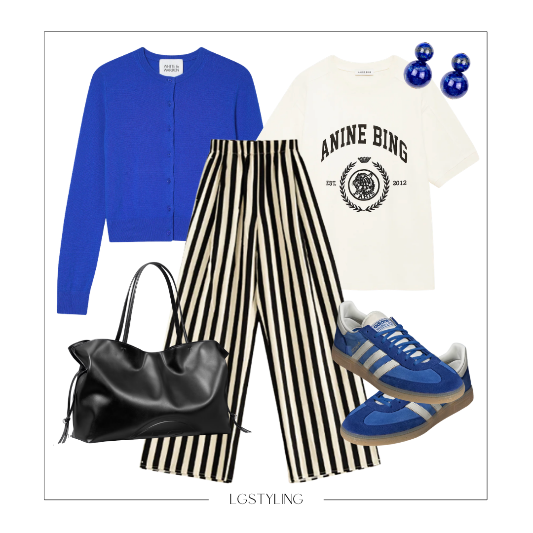 A blue cardigan, a white graphic T-shirt, black and white striped wide-leg pants, blue sneakers, a black handbag, and blue earrings.