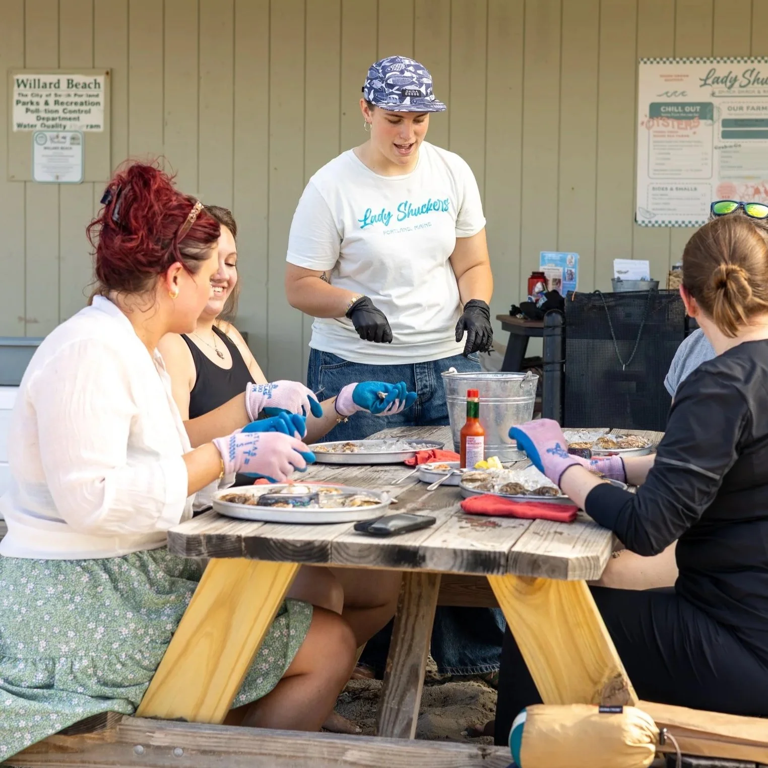 A group of women shucking Maine oysters at a Learn to Shuck oysters class in Portland, Maine