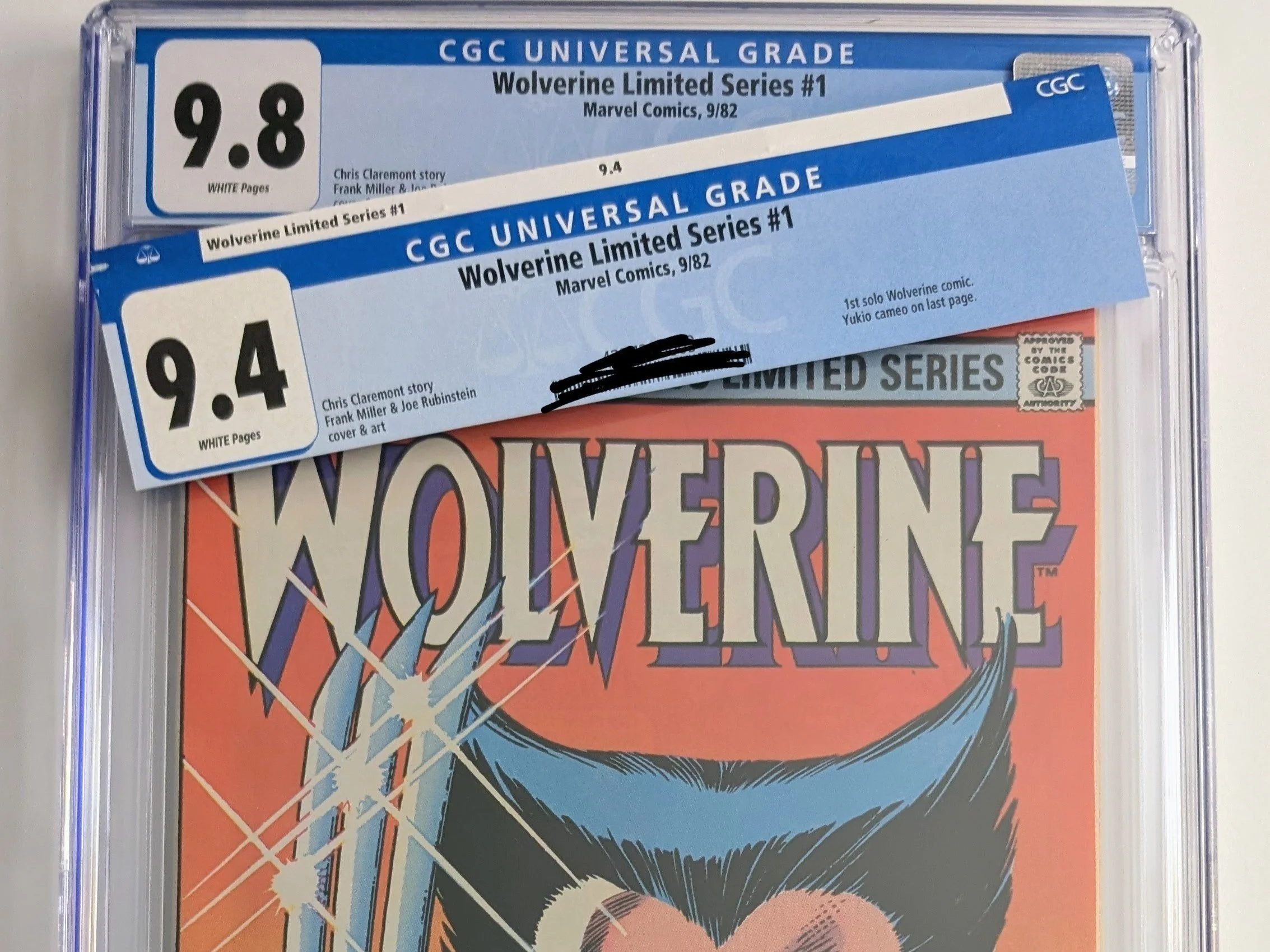 Close-up of a graded comic book cover featuring Wolverine. The grading labels show a 9.8 for the comic and a 9.4 for the accompanying loose pages. The comic is from Marvel Comics, 9/82, Wolverine Limited Series #1.