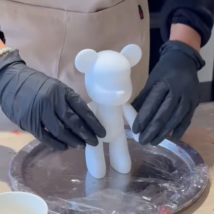 The bear is having it's arms and legs straightened
