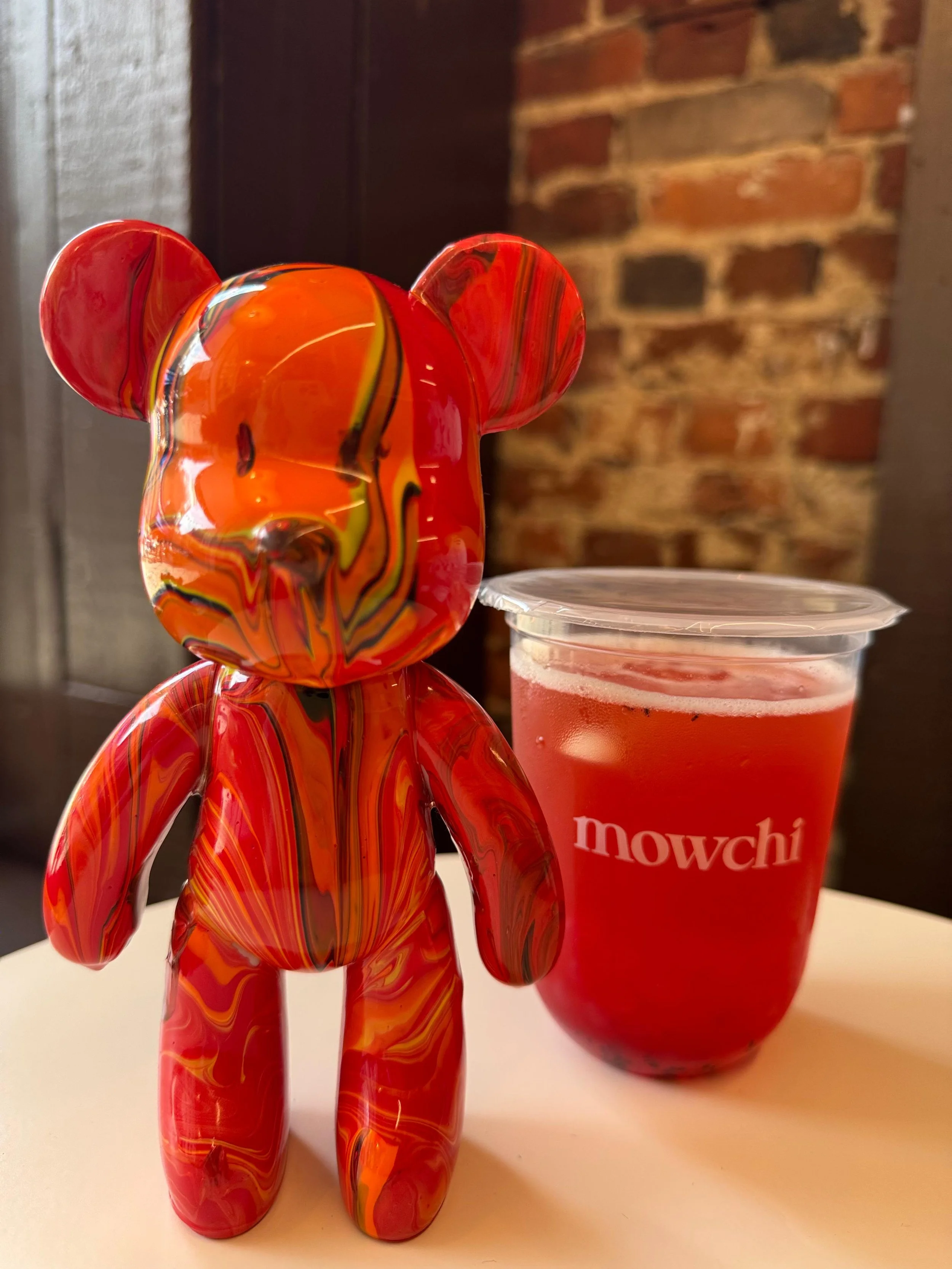 A red bear next to a Mowchi drink