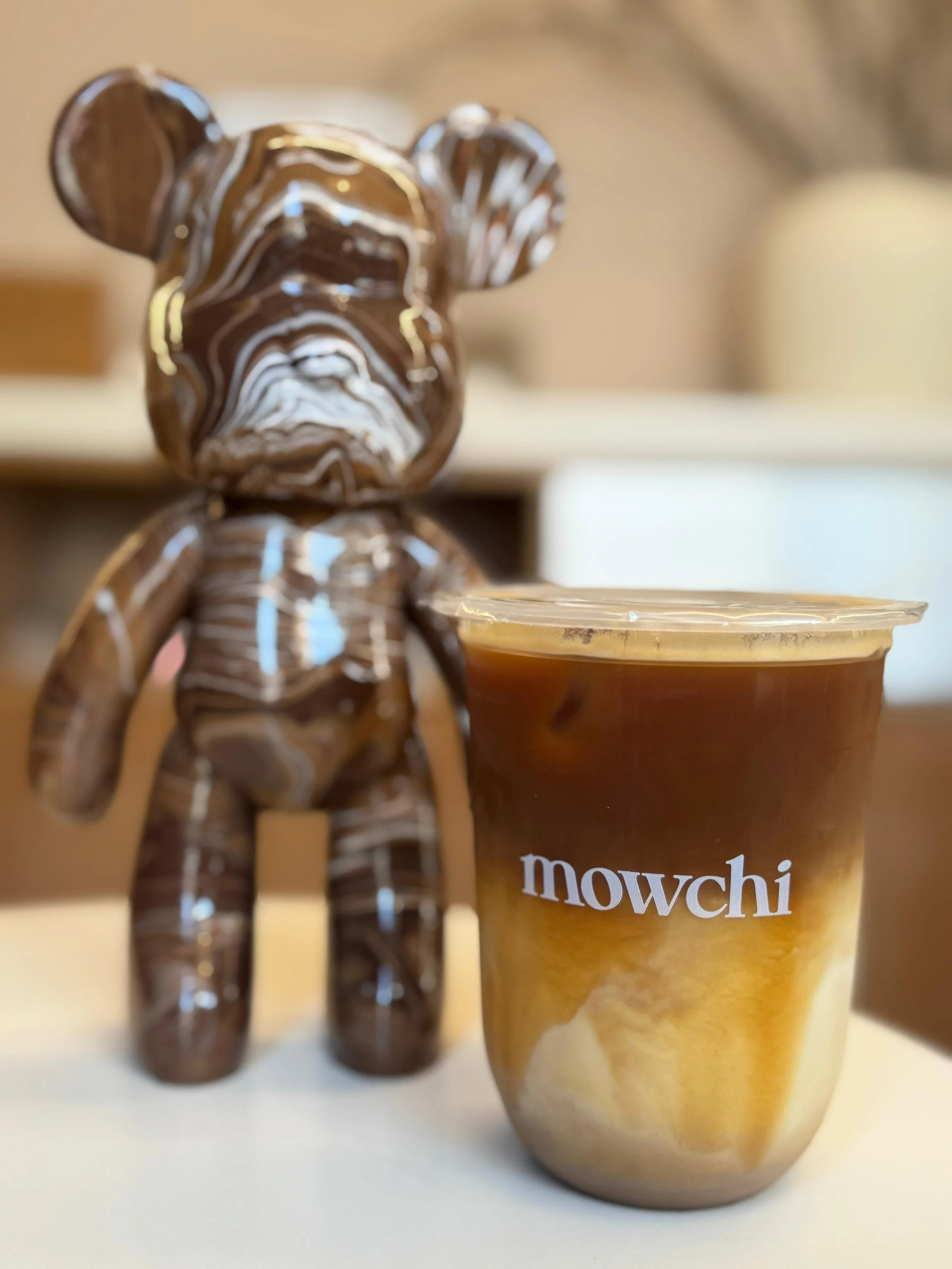 Brown bear next to a Mowchi coffee