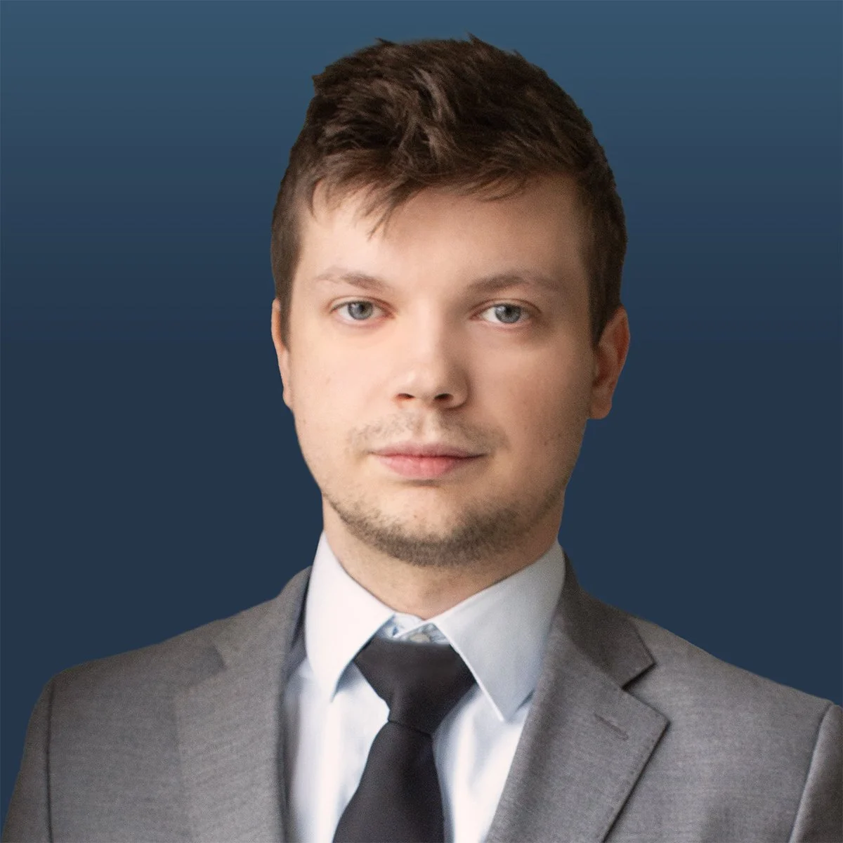 Confident young male in a suit on a navy background