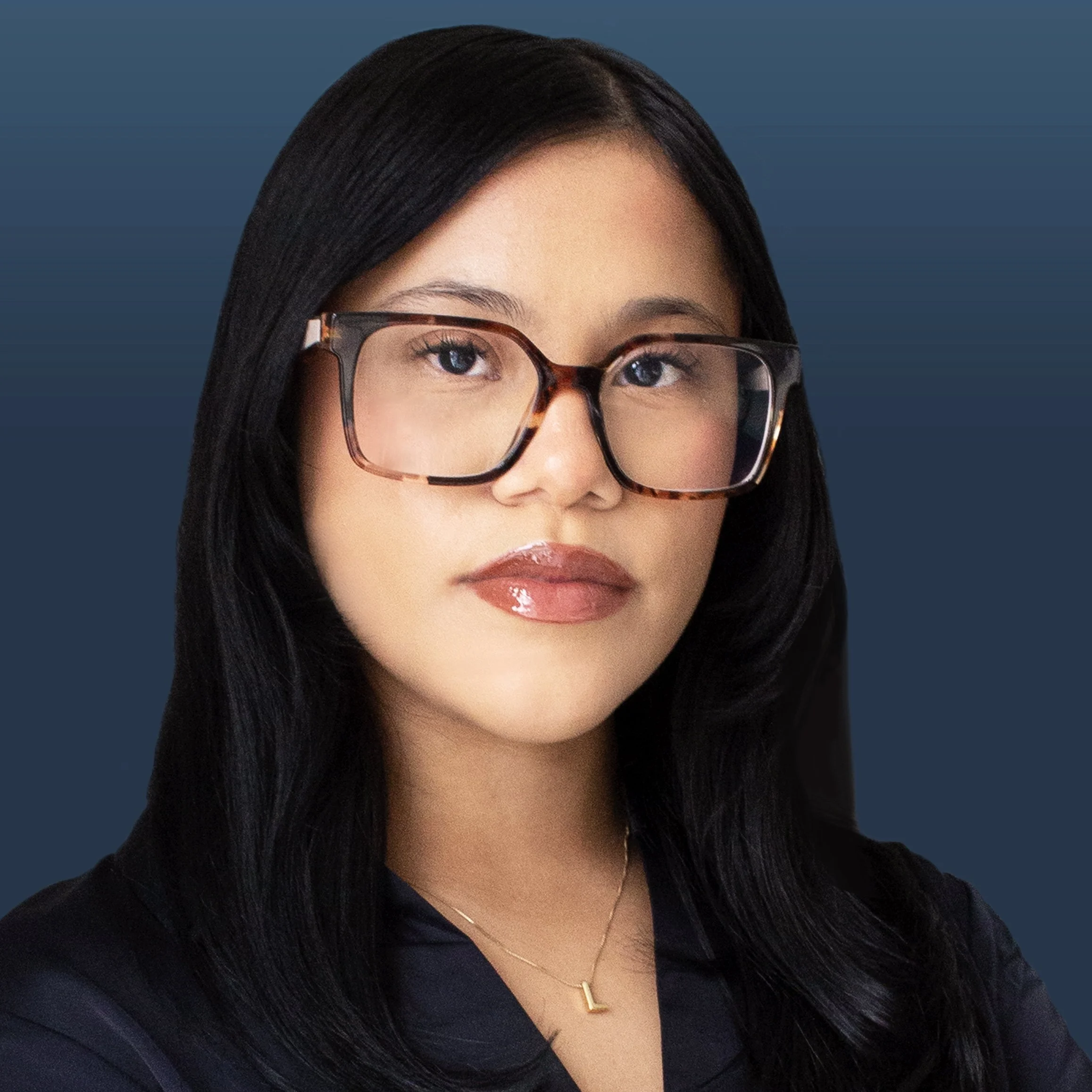 A woman with long dark hair wearing glasses with a tortoiseshell pattern and a black top, against a dark blue background.