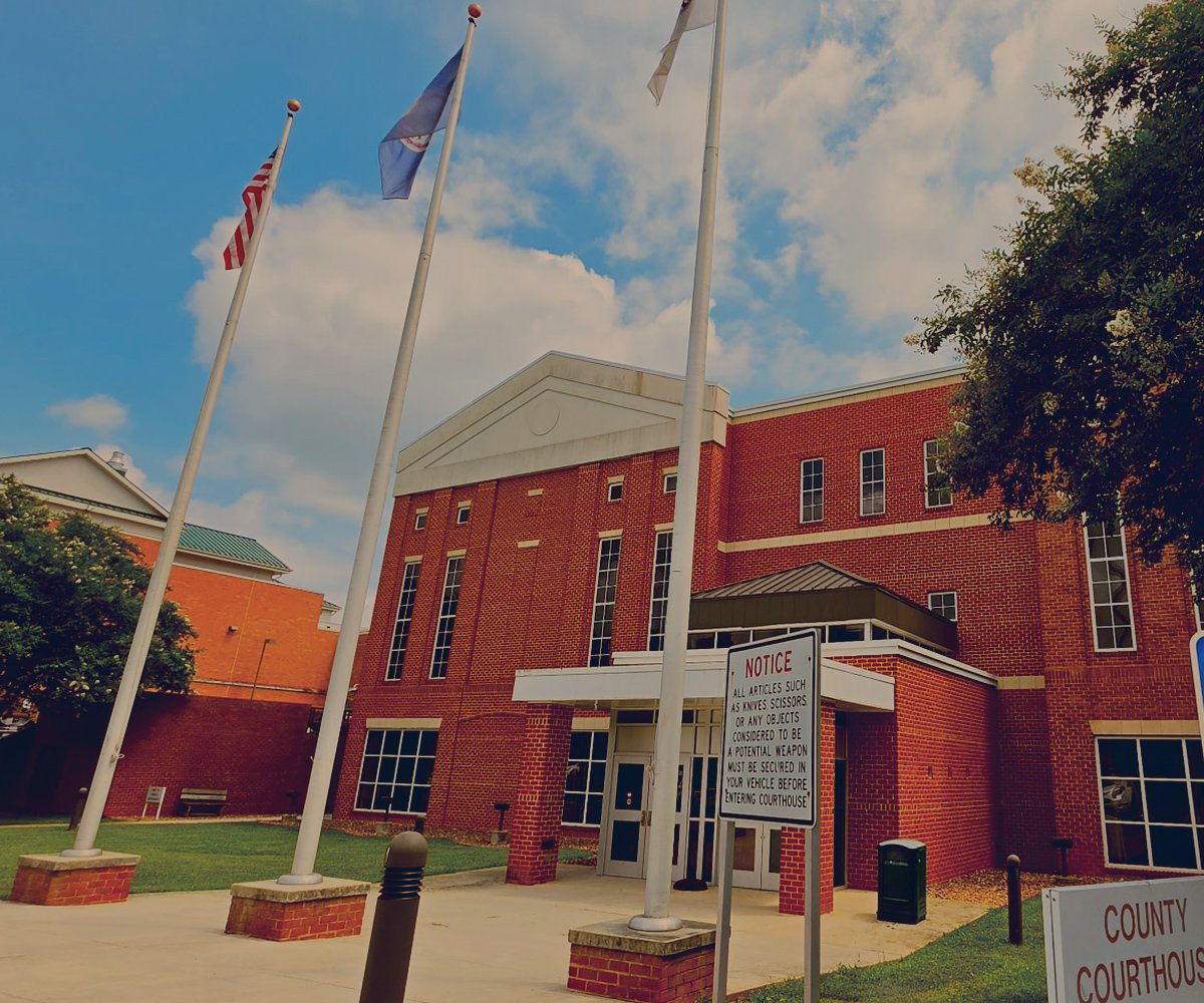 Front of the Campbell County Courthouse with flags against blue sky