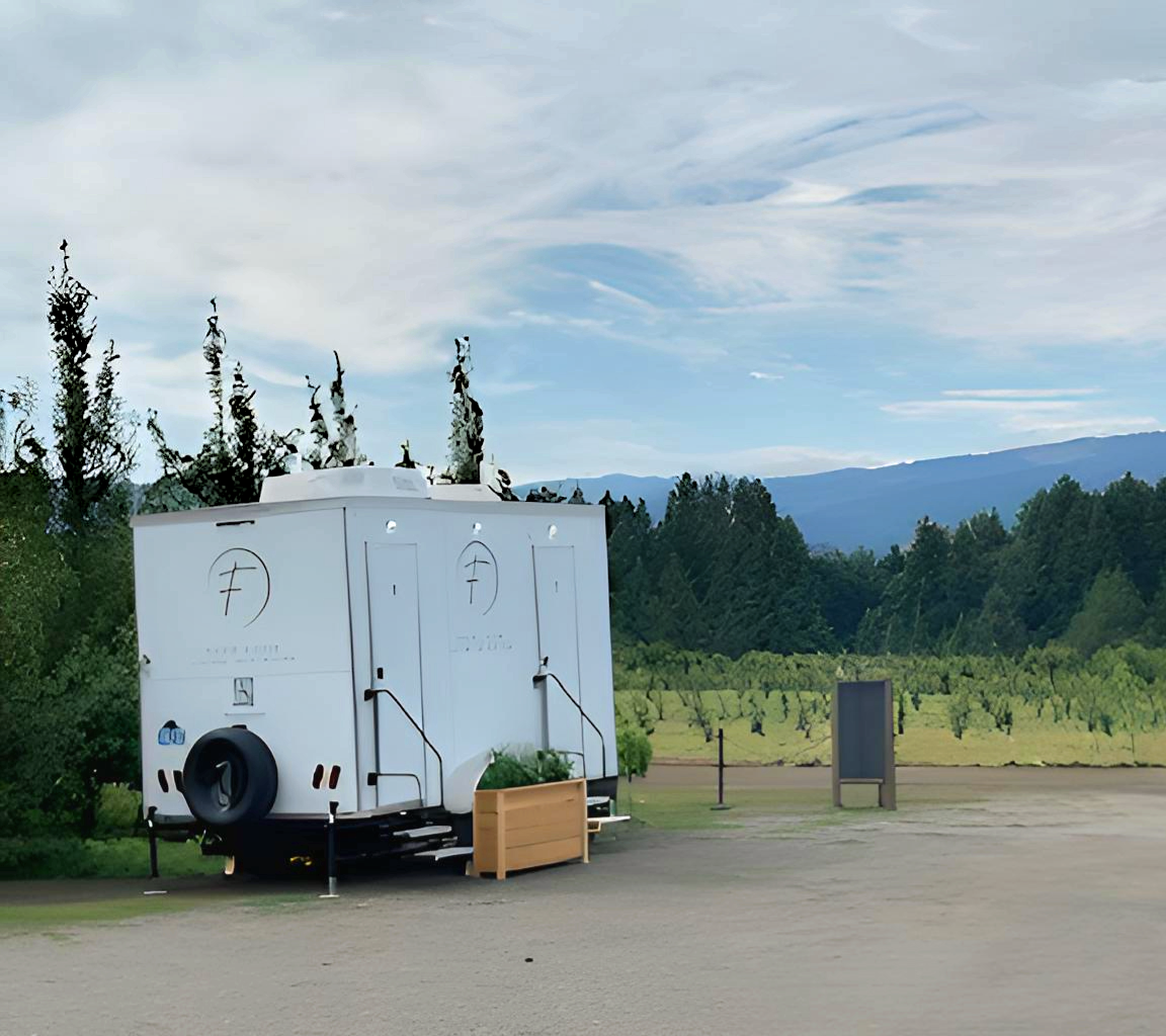 foxy loos luxury restroom trailer at a country side event location.  Elegant portable restroom solution with modern amenities, interior lighting, and premium finishes for weddings, festivals and special events in Hood River, OR and the Columbia gorge