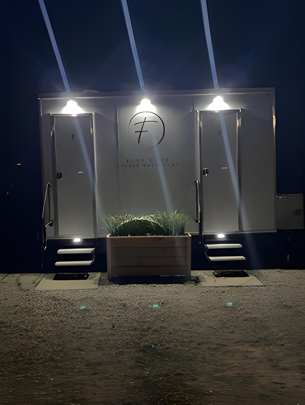 foxy loos luxury restroom trailer rental at night with illuminated entrances, upscale amenities, and premium guest accommodations.  Ideal for weddings, outdoor receptions, corporate events, and private celebrations throughout Oregon and Washington