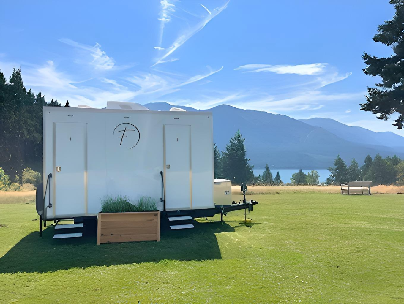 luxury restroom trailer rental at a scenic outdoor venue in the pacific northwest.  Premium mobile restroom featuring modern amenities, elegant design, and comfortable accommodations for weddings, festivals, corporate events, and special occasions th