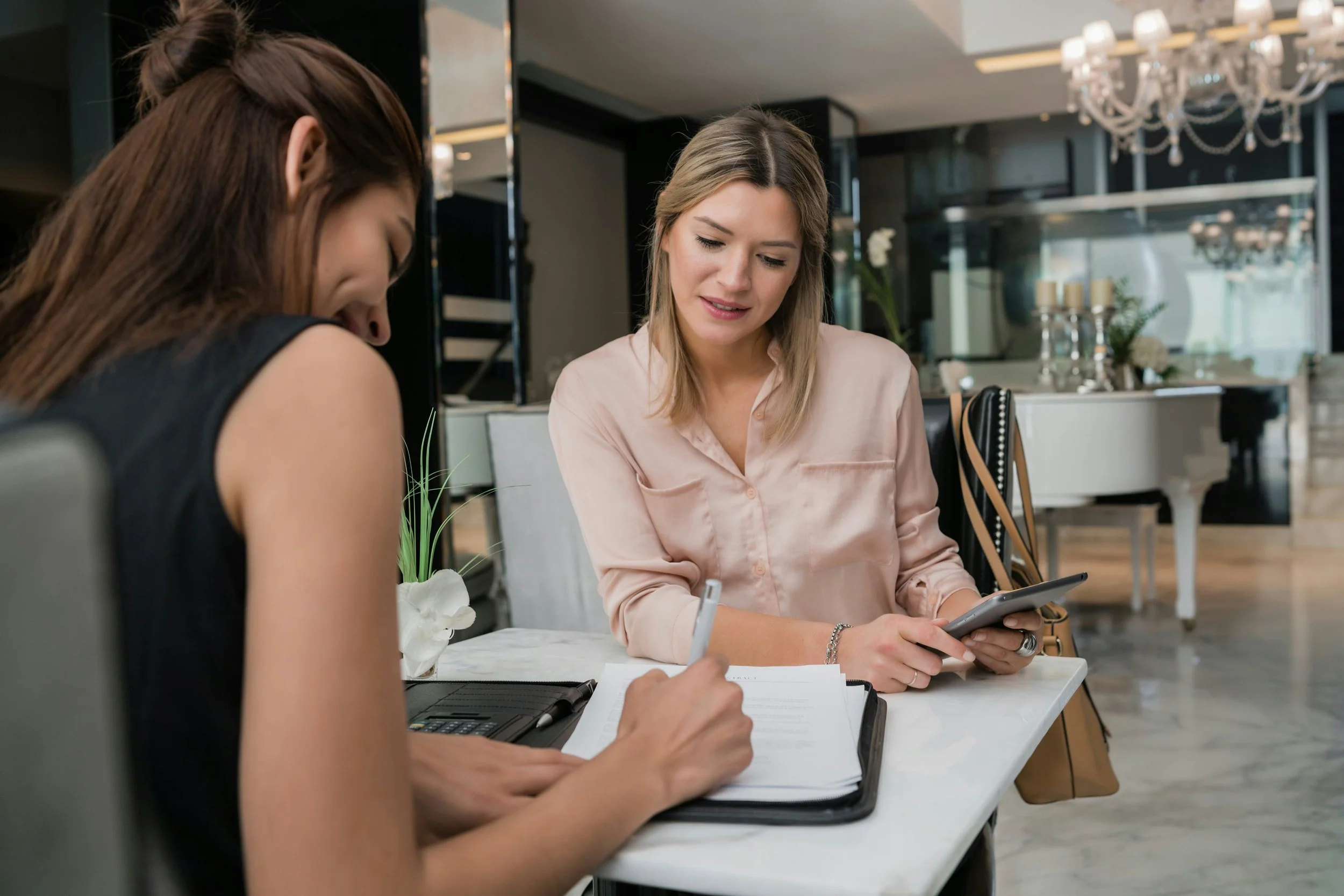 assistant interview and signing paperwork on desk