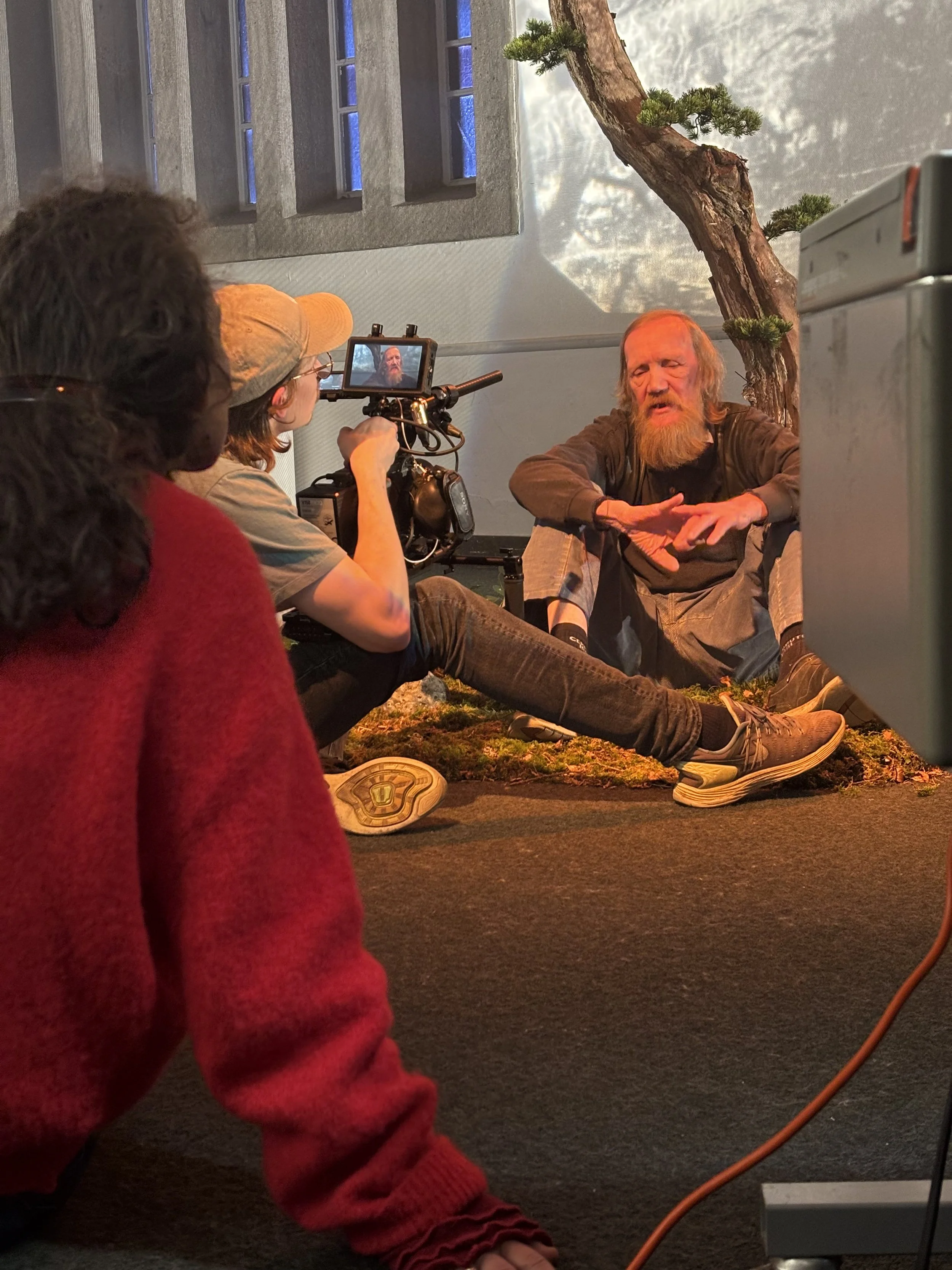 Personer under filmoptagelse, hvor en mand sidder på gulvet | Dokumentarfilm | Retrograd | Esben Persson & Anders Mielcke | Filmproduktion Aarhus | GESTALT