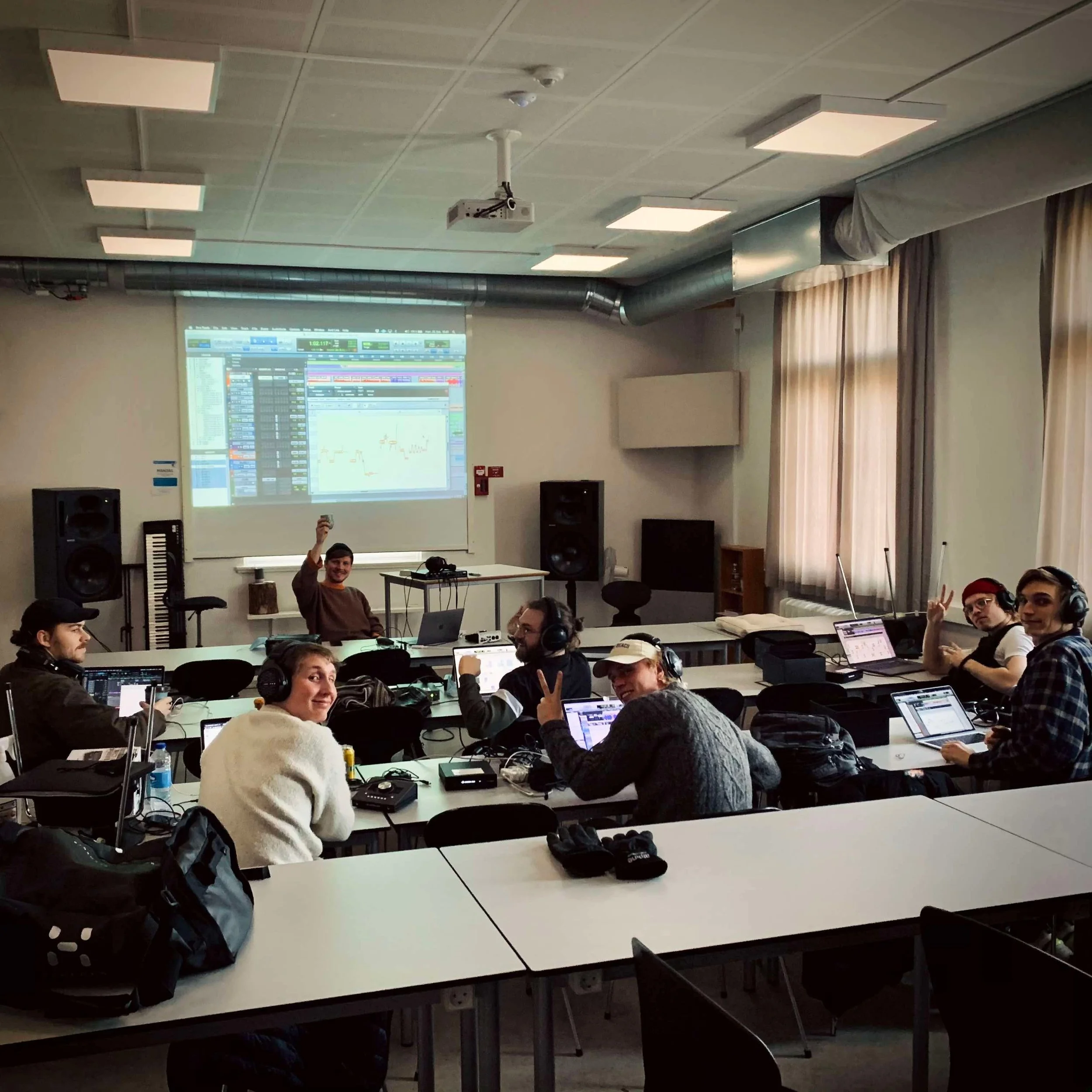 En gruppe mennesker i et studiemiljø med musikudstyr og computere | Musikkomposition | Studieproduktion og lyddesign | Filmproduktion Aarhus | GESTALT