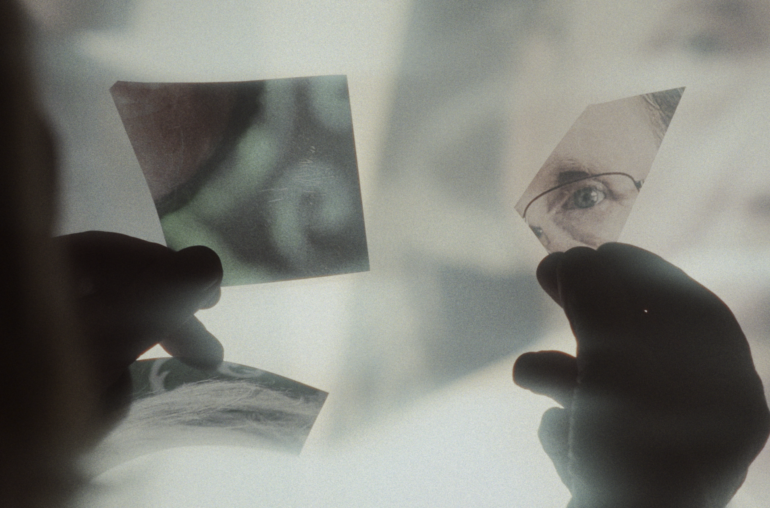 Hænder holder tre fotos, ét med et øje, ét med en mund, og ét med en arm og en hånd | Dokumentarfilm | Retrograd | Esben Persson & Anders Mielcke | Filmproduktion Aarhus | GESTALT