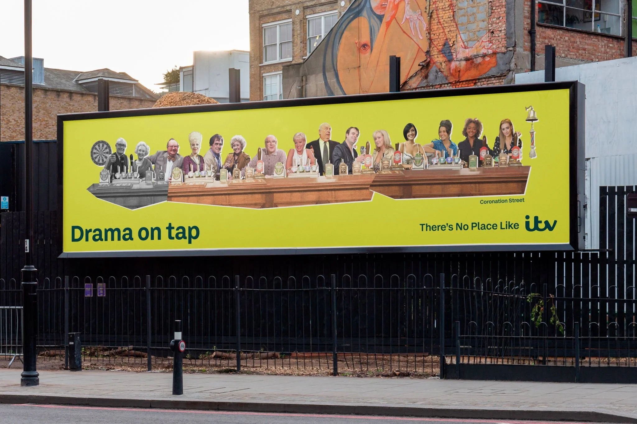coronation street billboard featuring past and present workers in the rovers return pub. Headline Drama on tap