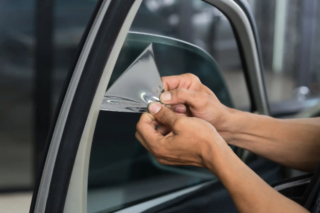 Reliable window tinting installation by Elite Pros Window Tinting, showing professional application of window film on a car window in Charlotte NC.