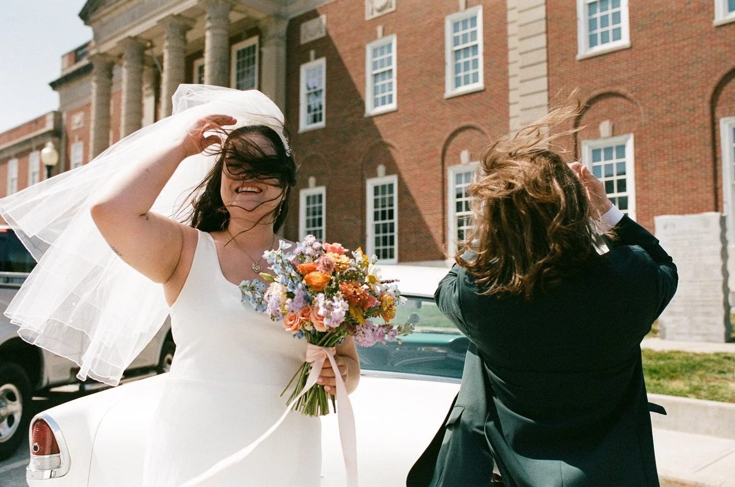 Jessy and Zach celebrating outside of the courthouse in the wind! 

Planning: @mercyfavrow 
Florals: @lovelilacs.kc