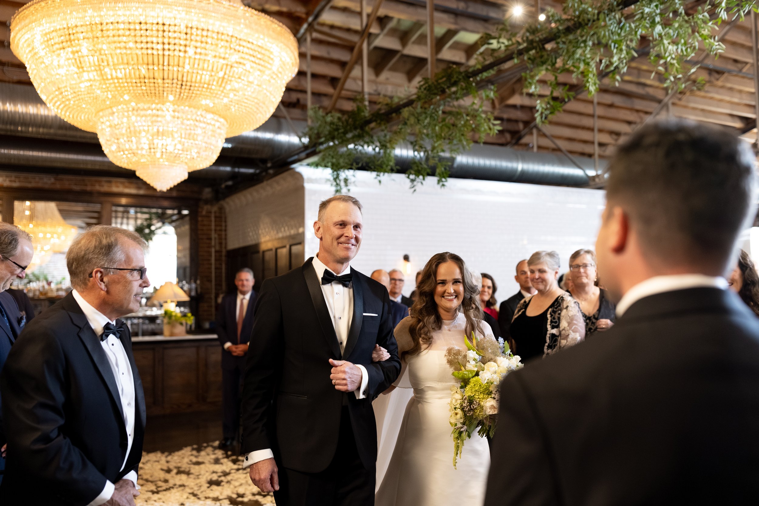 Gracie and her dad walking down the aisle to Tom.