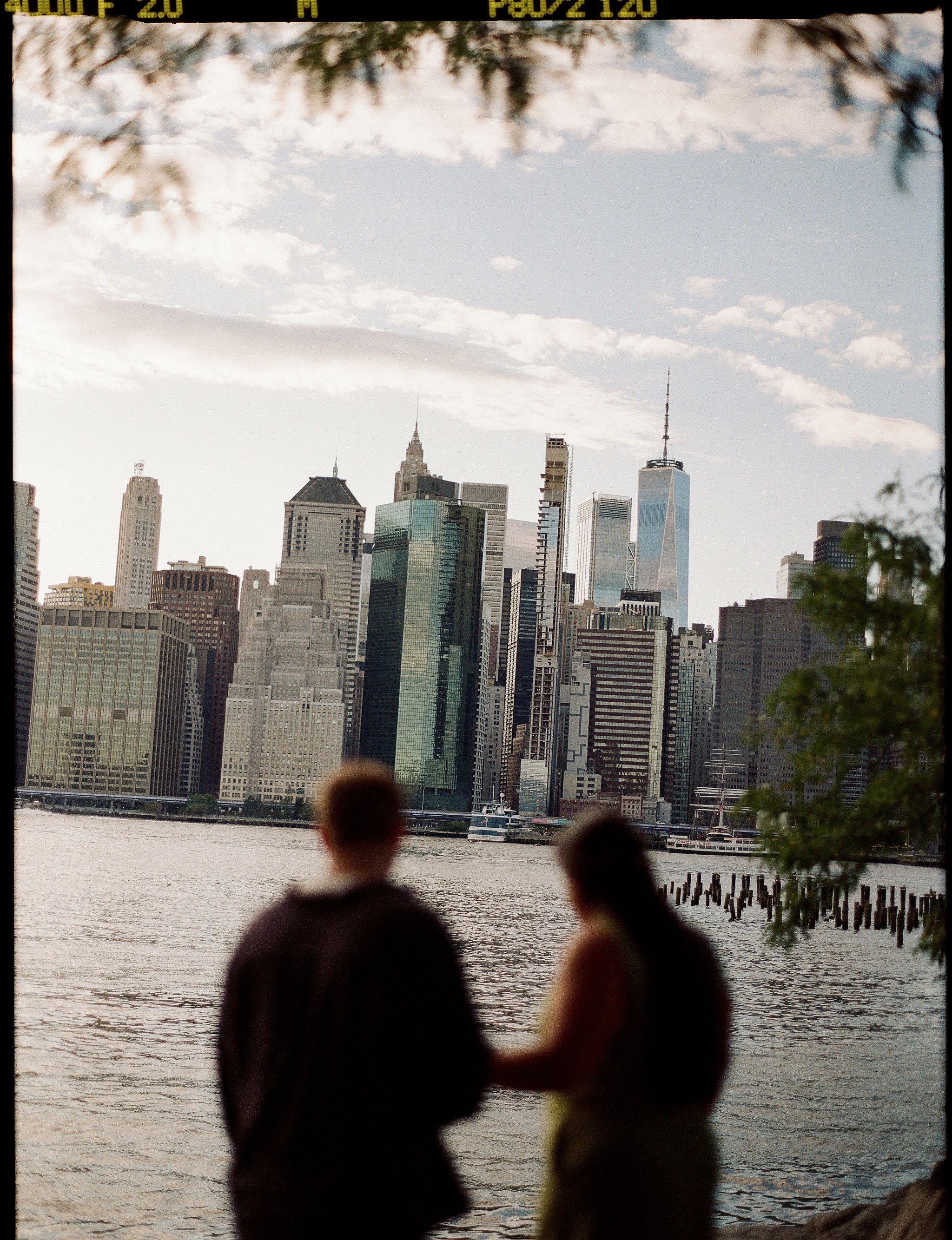 Photo of a couple at the Brooklyn Bridge Park in New York City on film.
