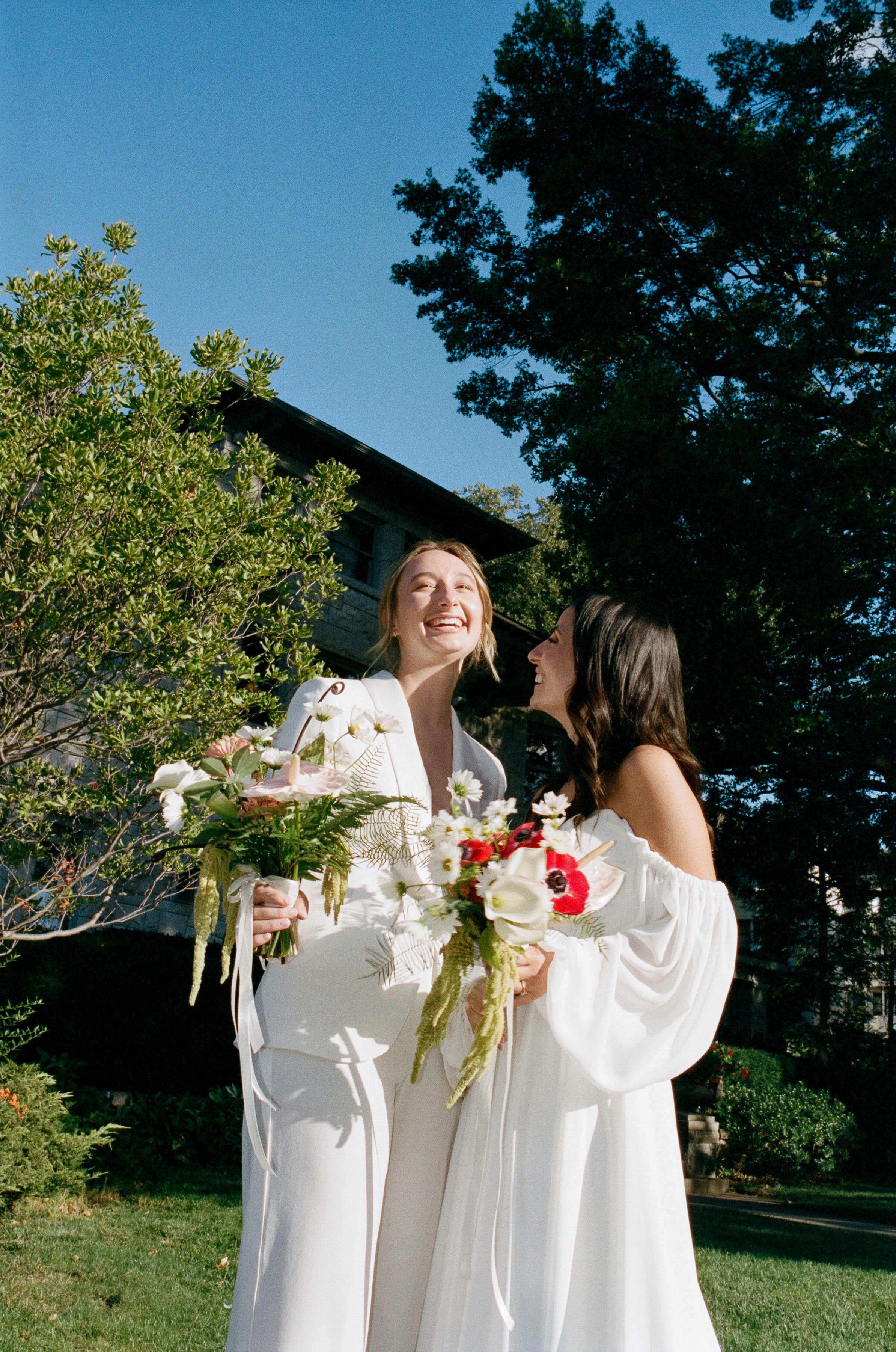 Queer couple on their wedding day in their wedding attire!