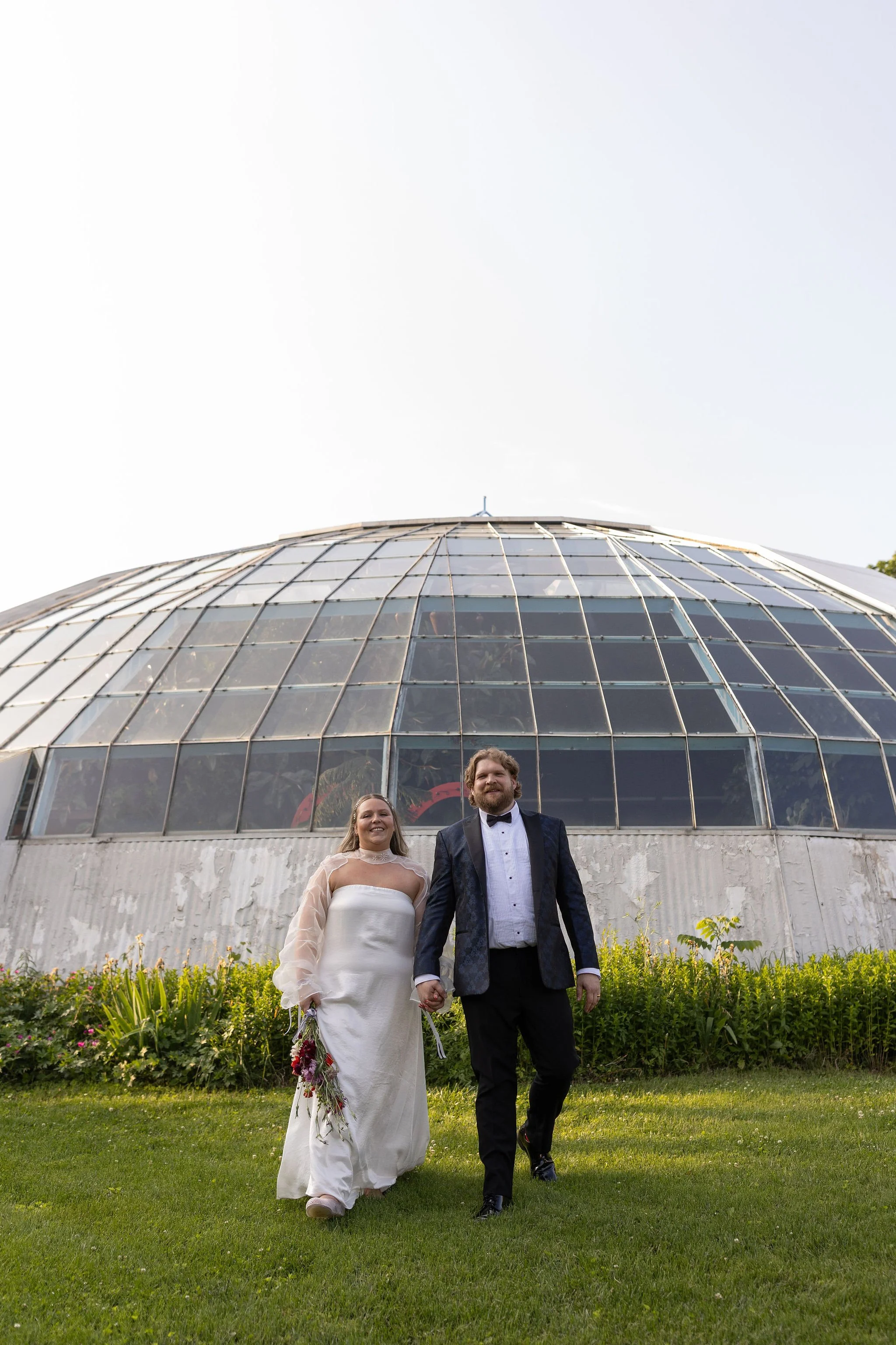 Photo of a couple in their wedding attire eloping at the campbell dome house in Kansas City.
