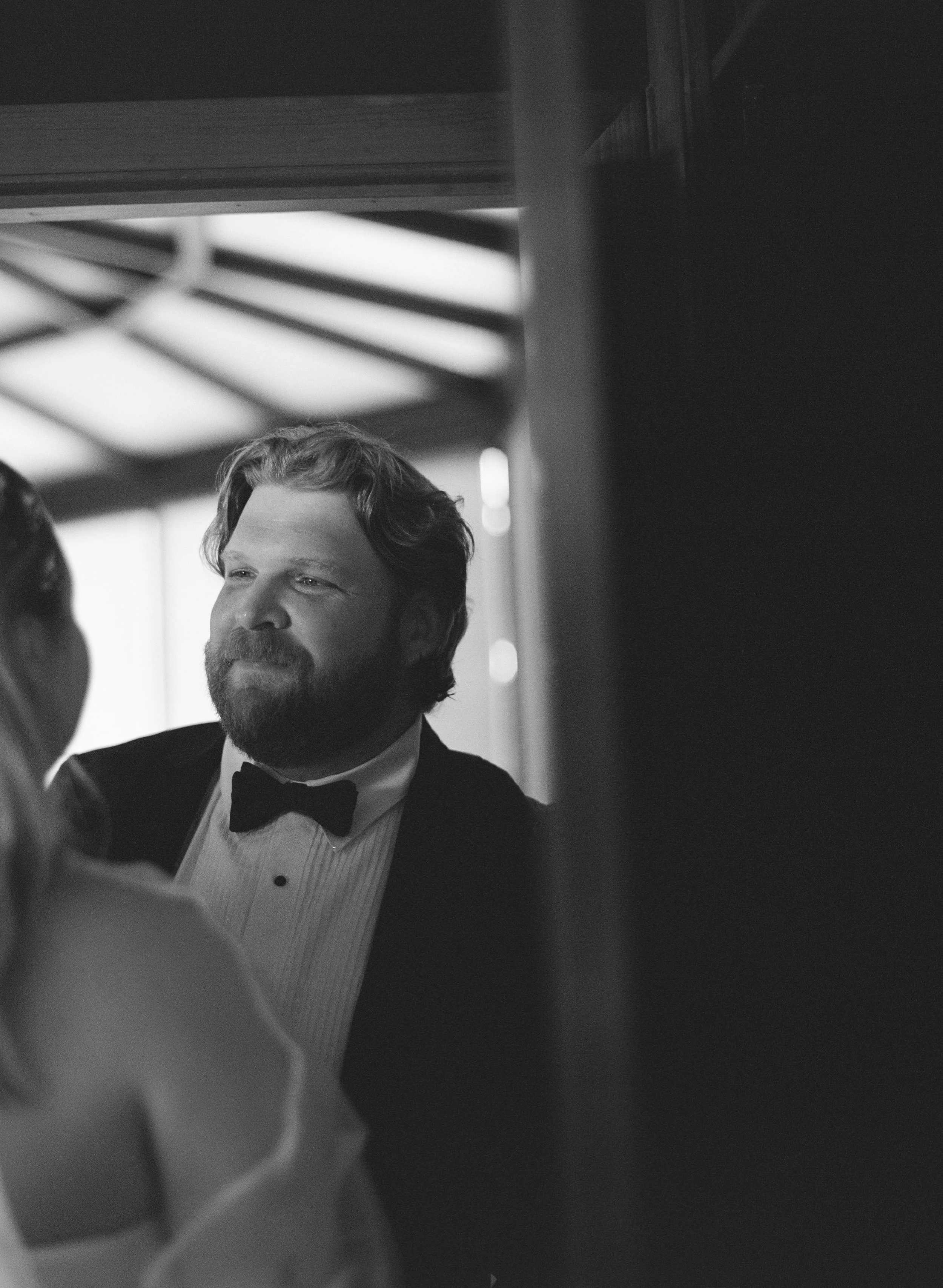 Portrait of Jason, looking at his bride, Melissa before their ceremony.