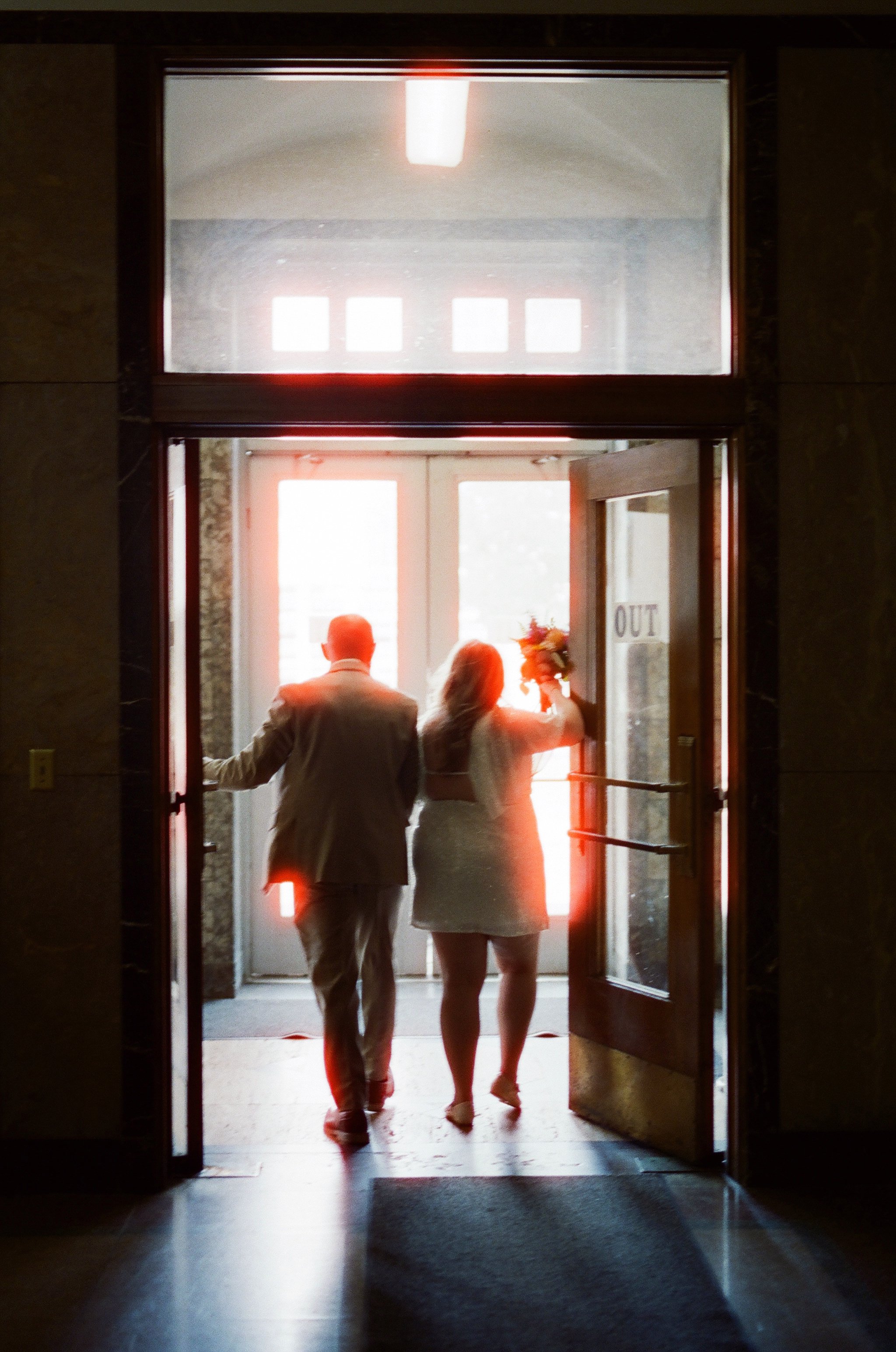 Photo of a couple exiting the jackson county courthouse after eloping.