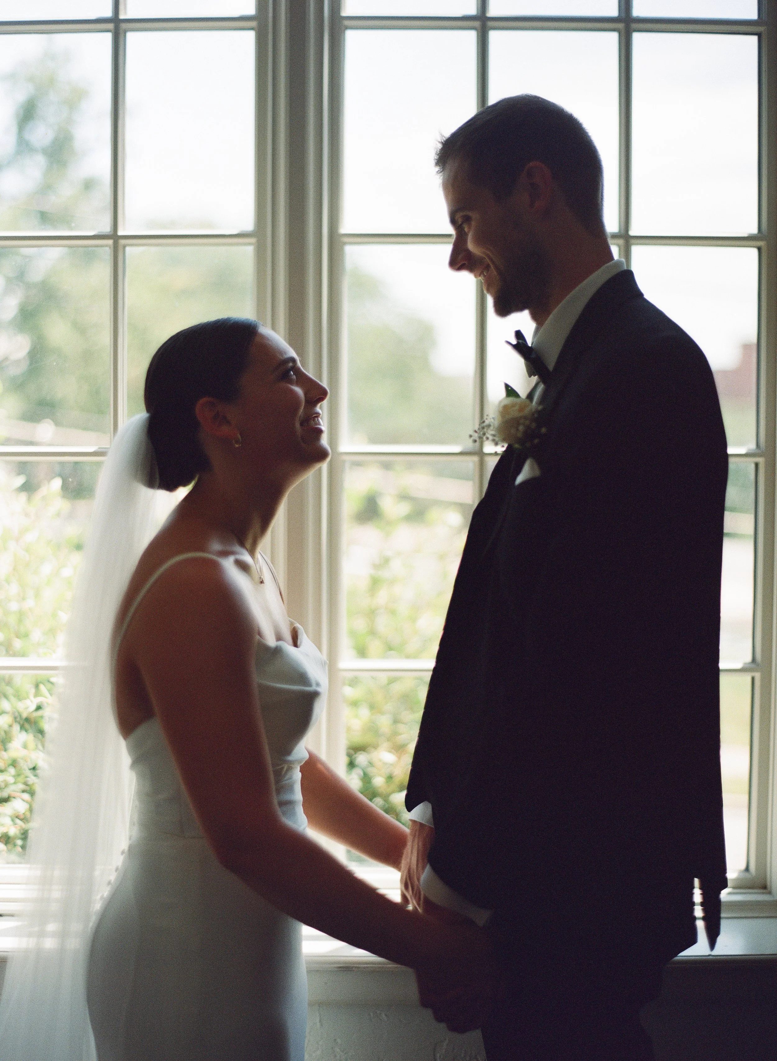 Couple in front of a window at La Villa in Kansas City