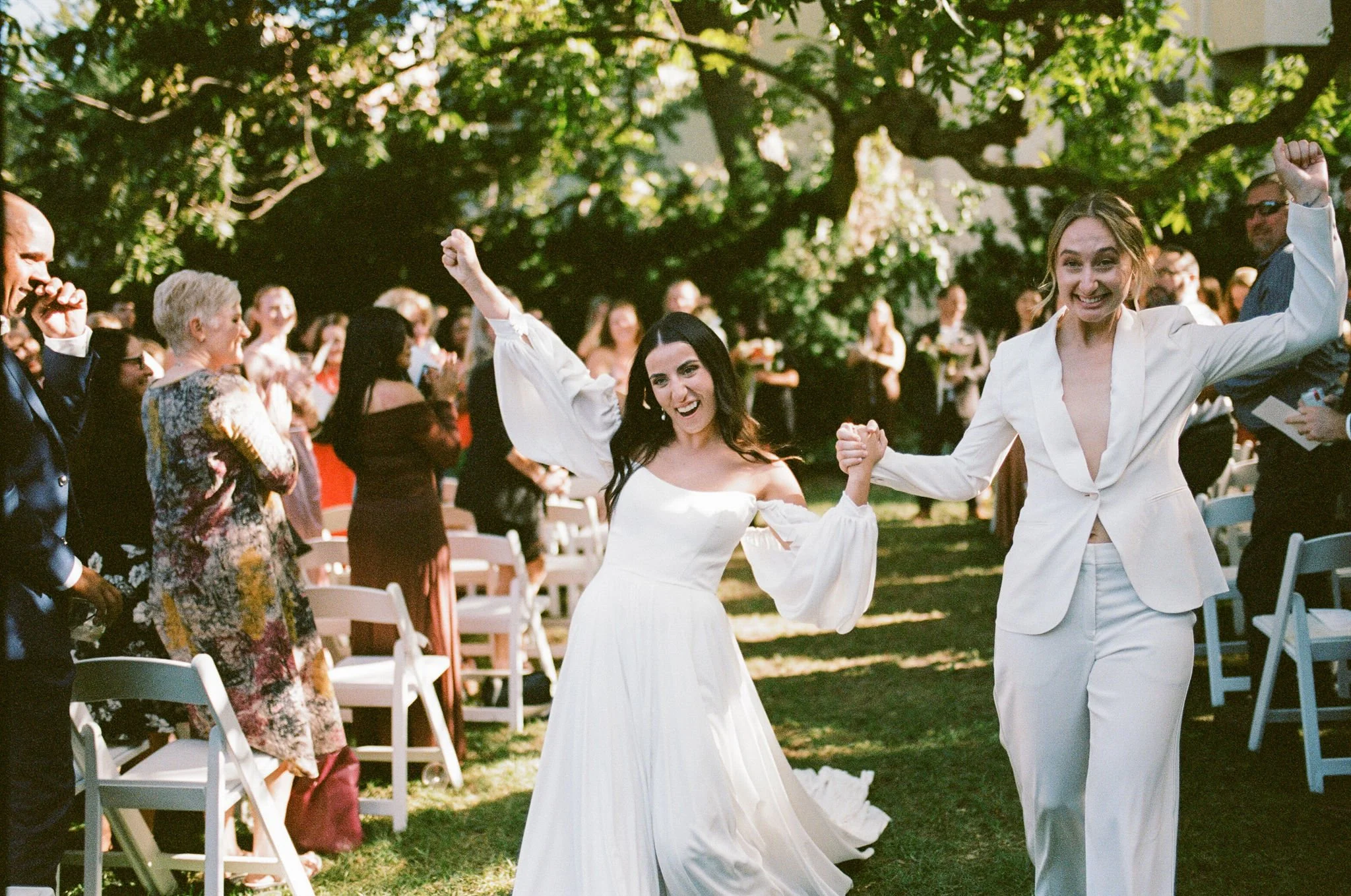 Photo of a lesbian couple celebrating together after their wedding ceremony.