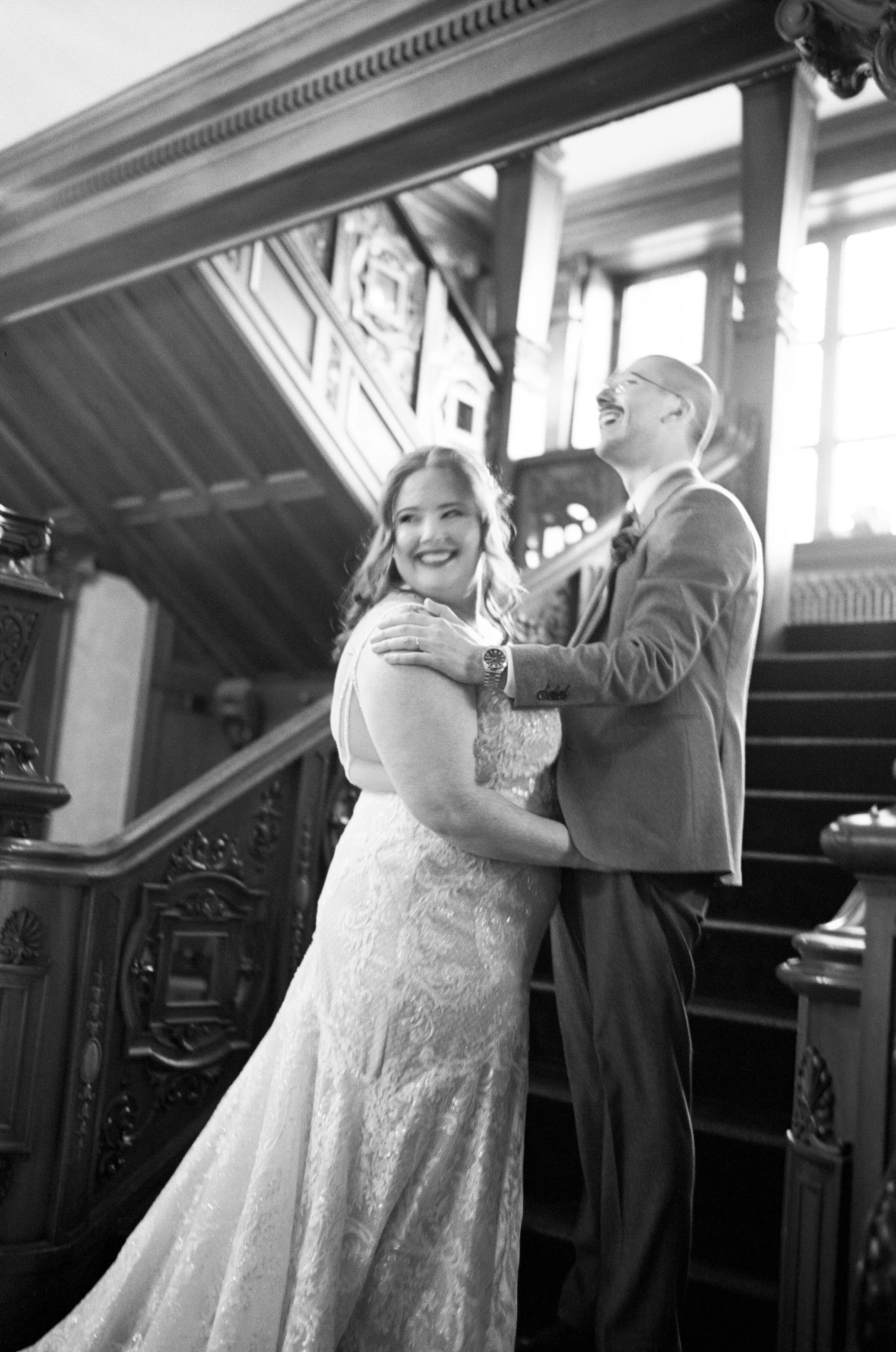 A couple getting married on the grand staircase at Loose Mansion.