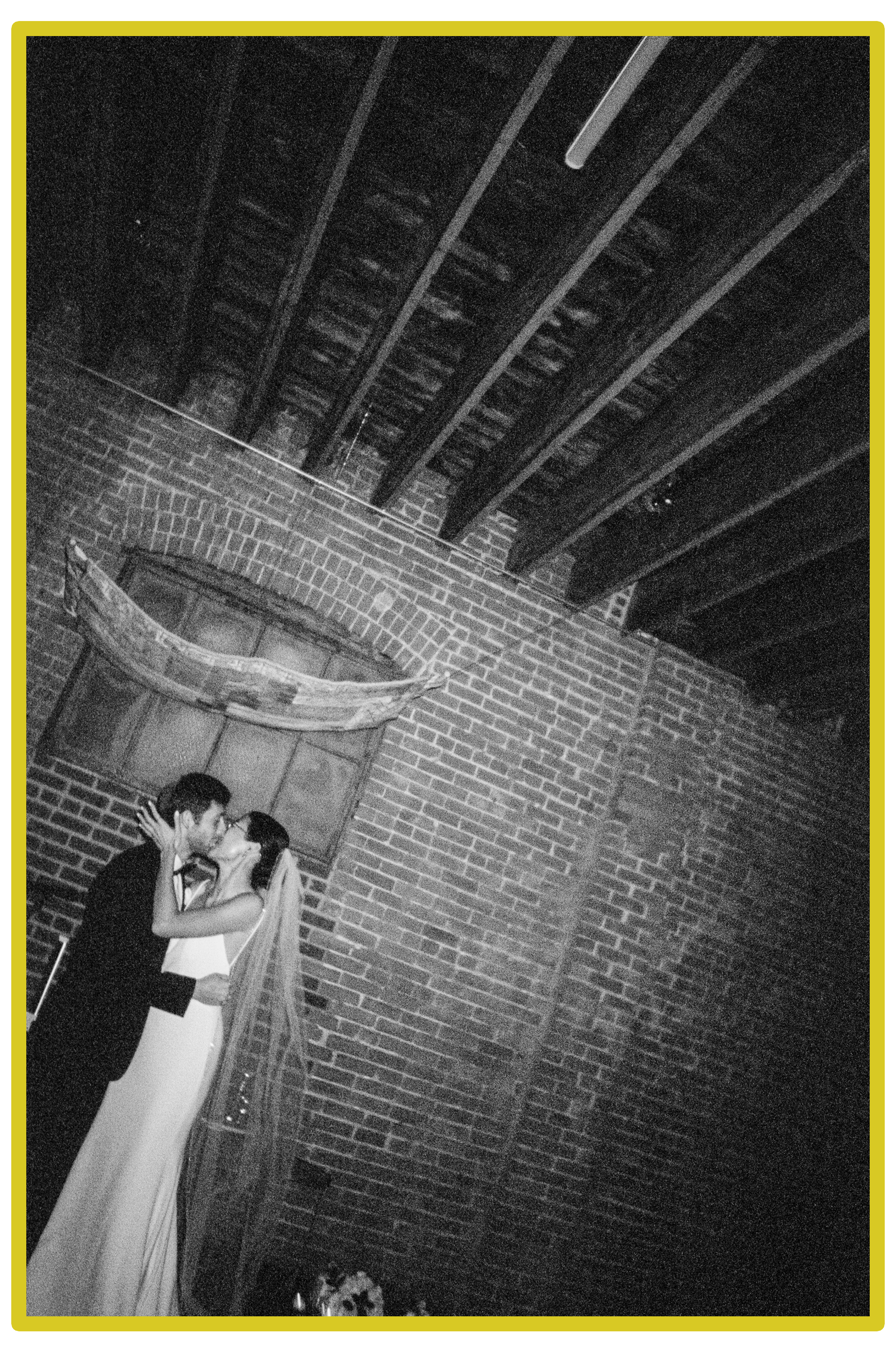 35mm film photograph of a couple kissing during their wedding ceremony