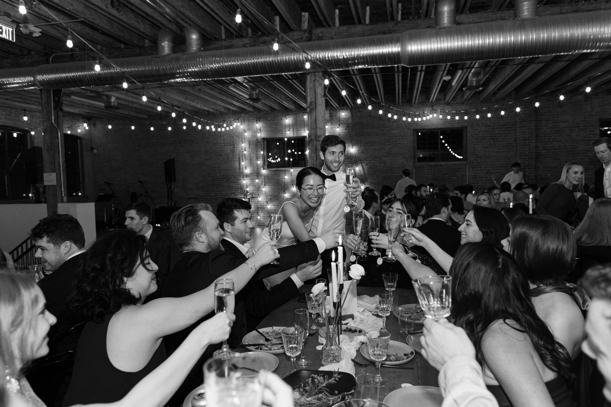Couple toasting with their guests at their wedding reception at UNION 828.