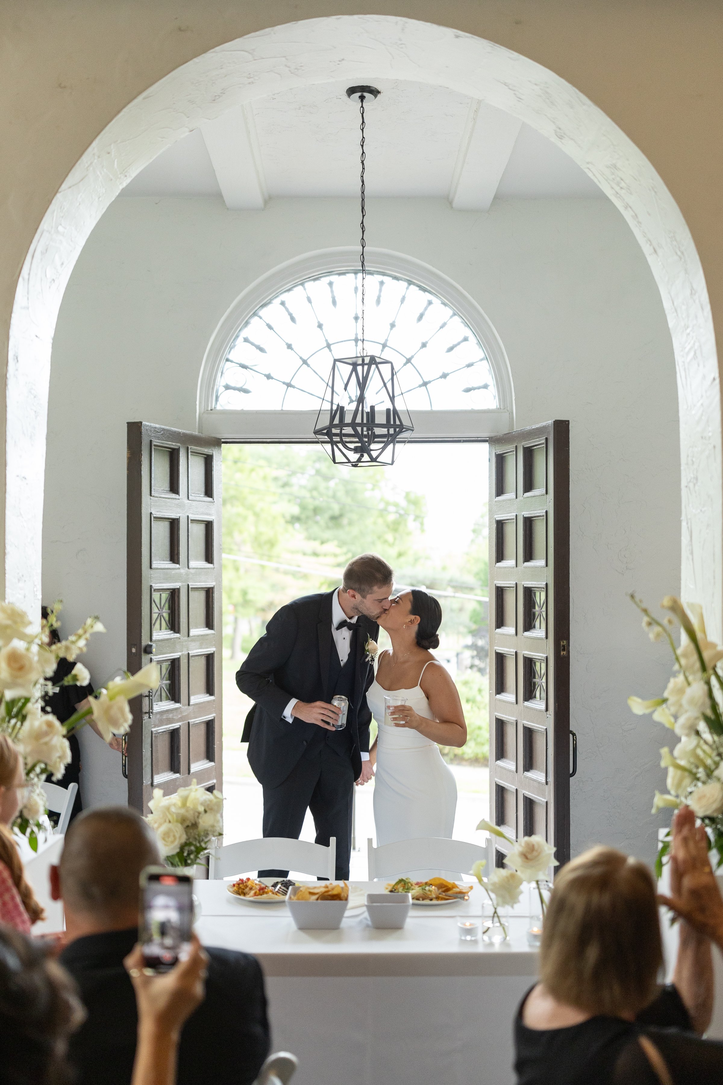 Couple entering into their wedding reception at La Villa in Kansas City, MO.