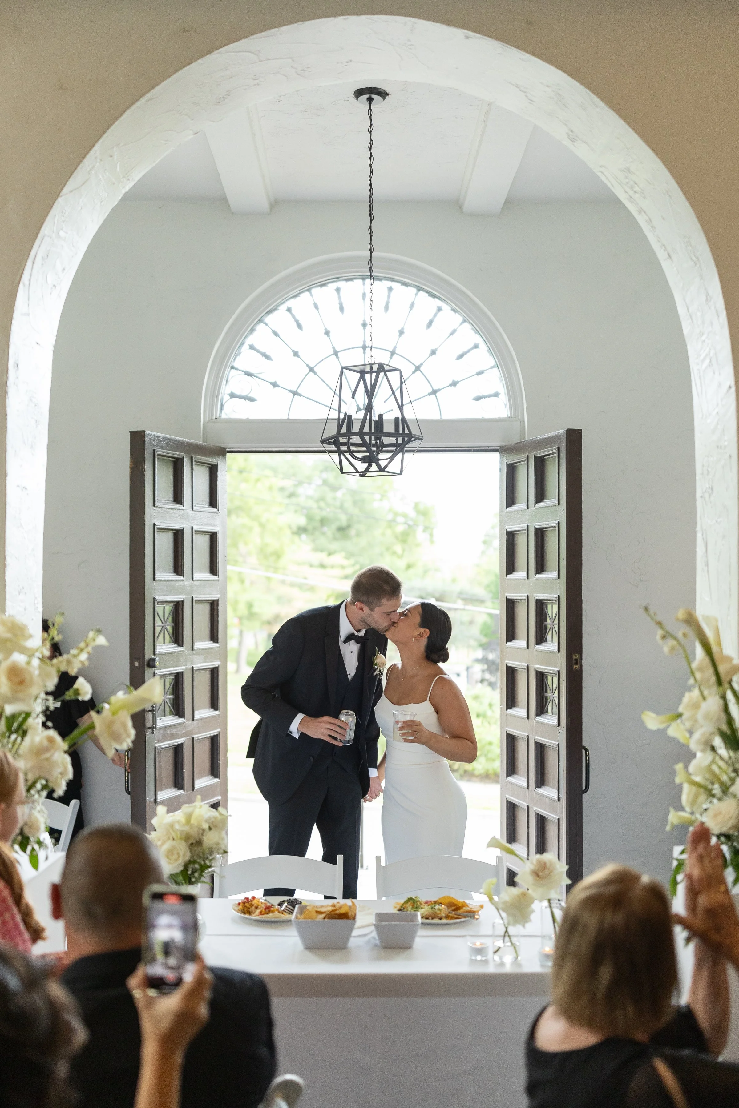 Couple entering into their wedding reception at La Villa in Kansas City, MO.