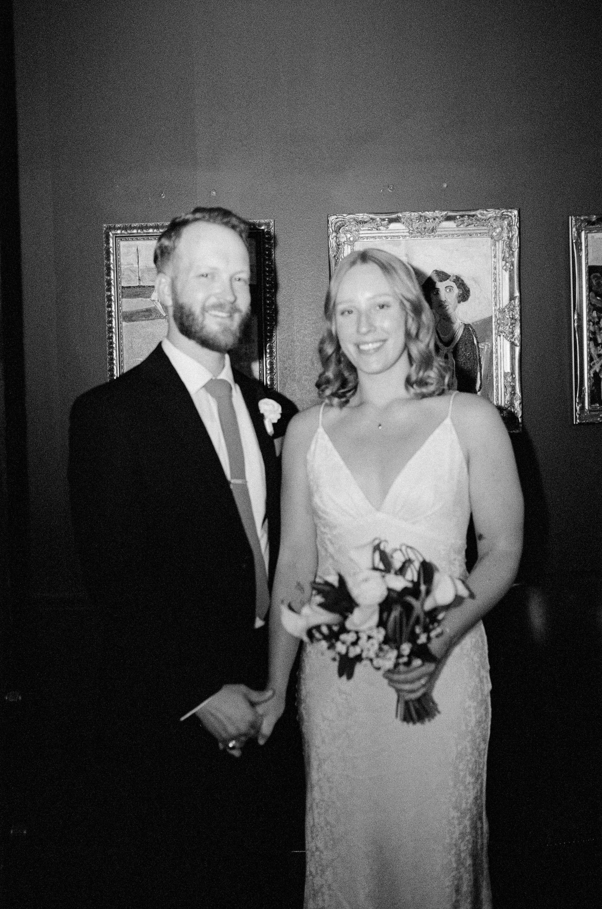 Photo of a couple getting married at Tom's Town Distillery back room.