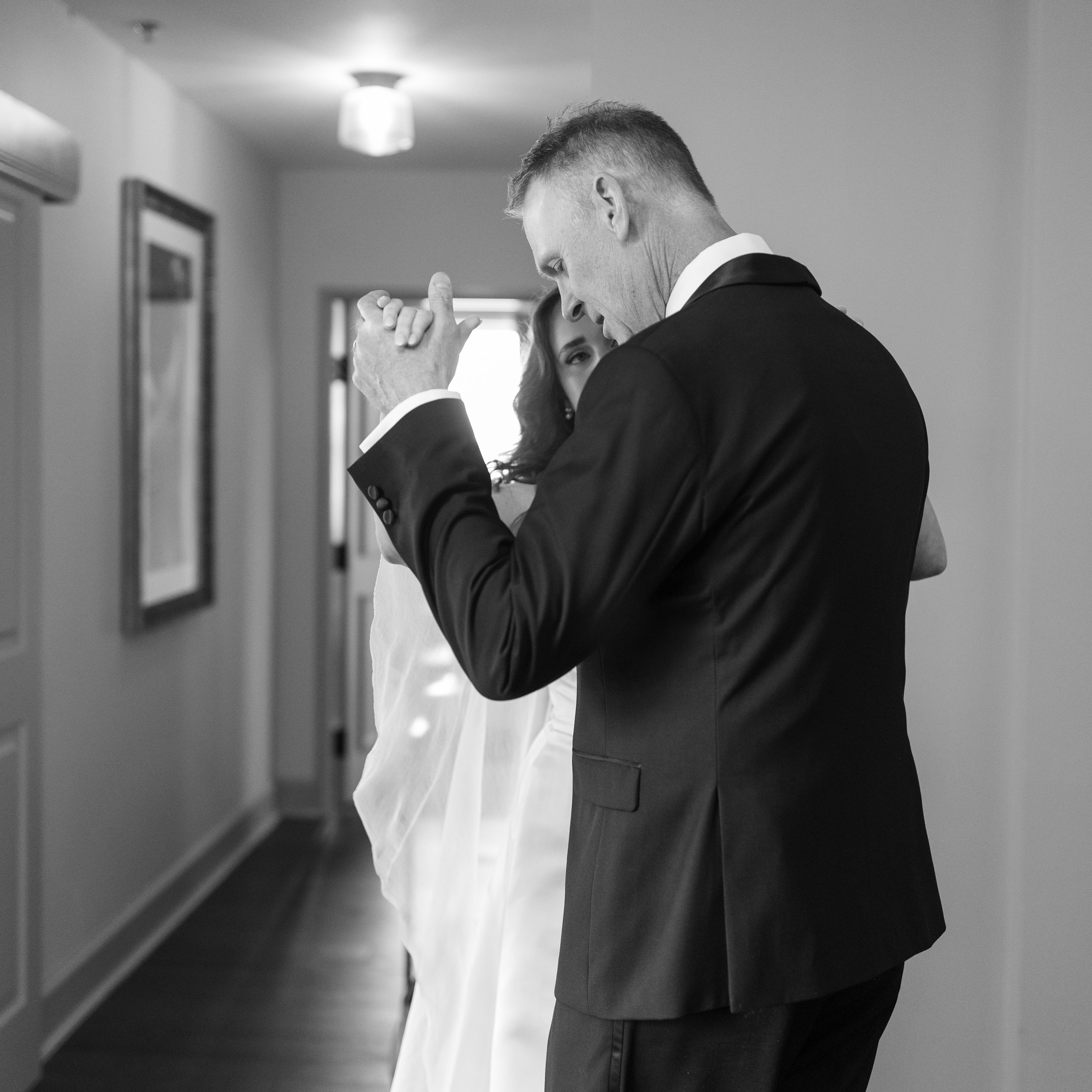 Gracie and her dad practicing their dance in the hotel room.