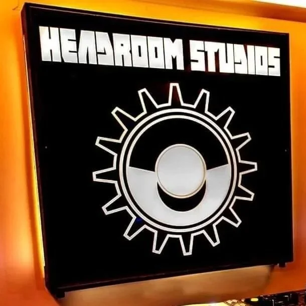 Photo of a black archive box labeled "Headroom Studio" with a gear and face mask graphic on the front.