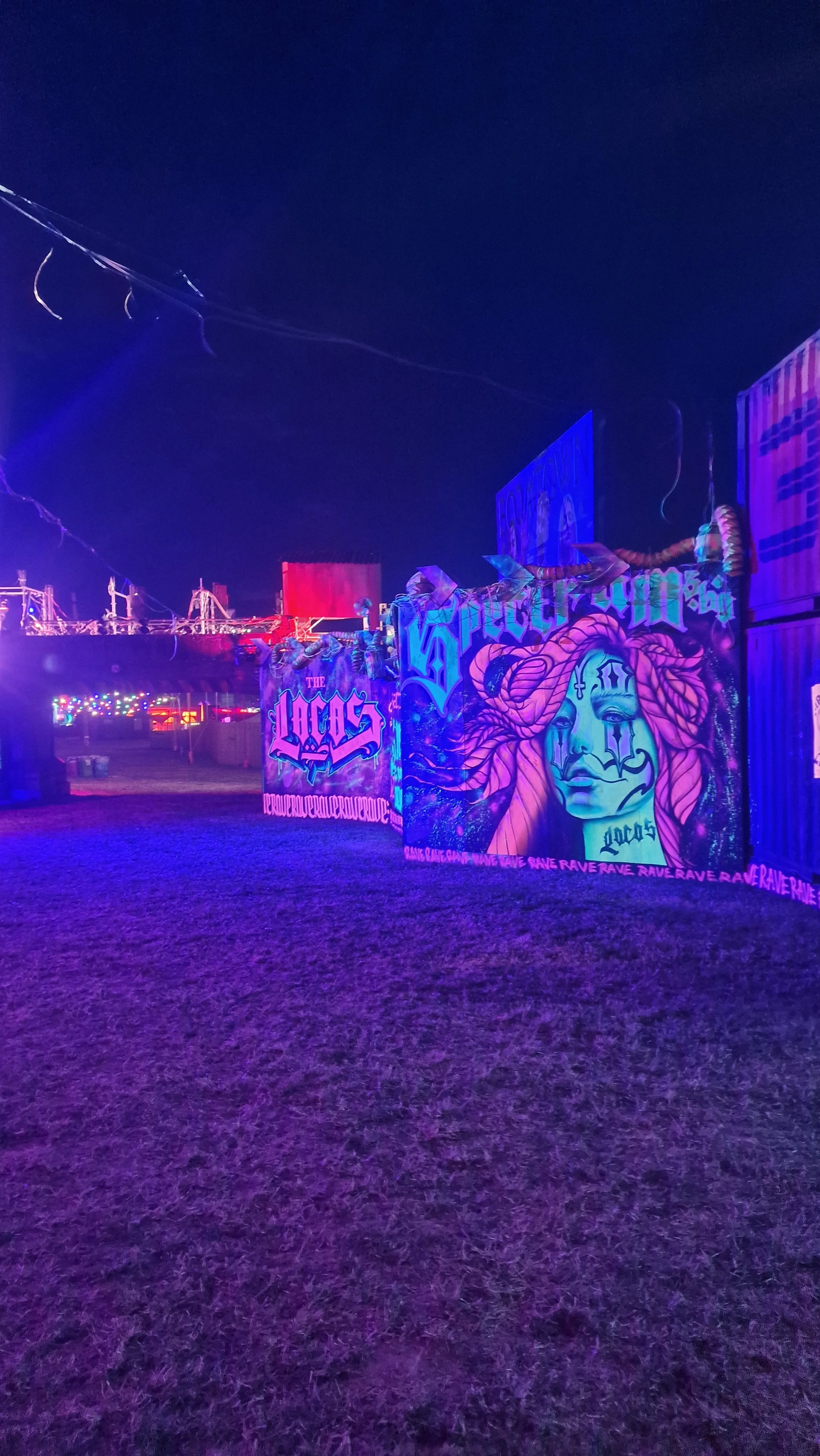 Graffiti artwork on shipping containers at night, with colorful neon lighting - Twelve34 Productions Boomtown
