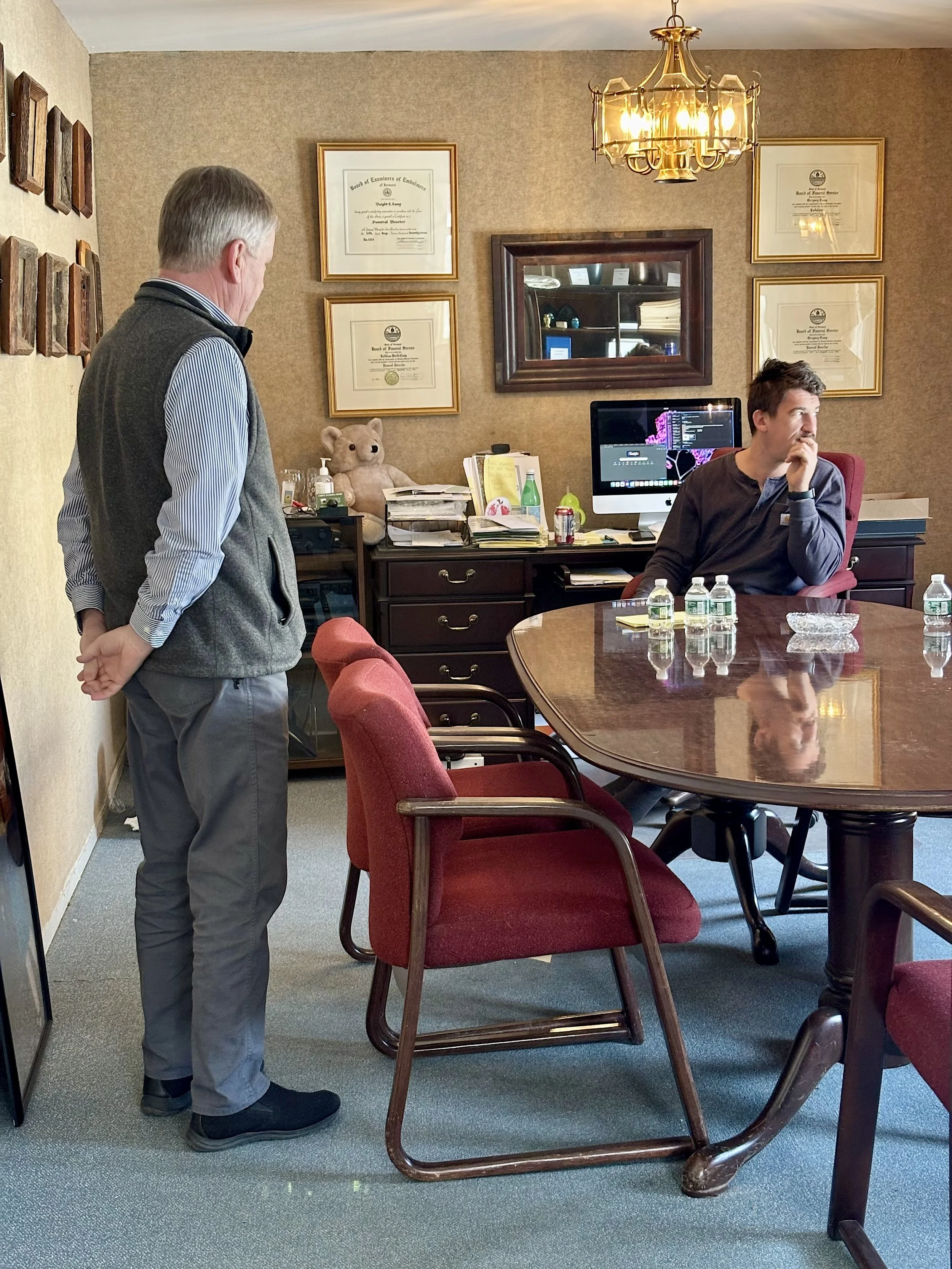 Greg (left)—with his son Jordan—meets with families in the same room that his great-grandfather did. 