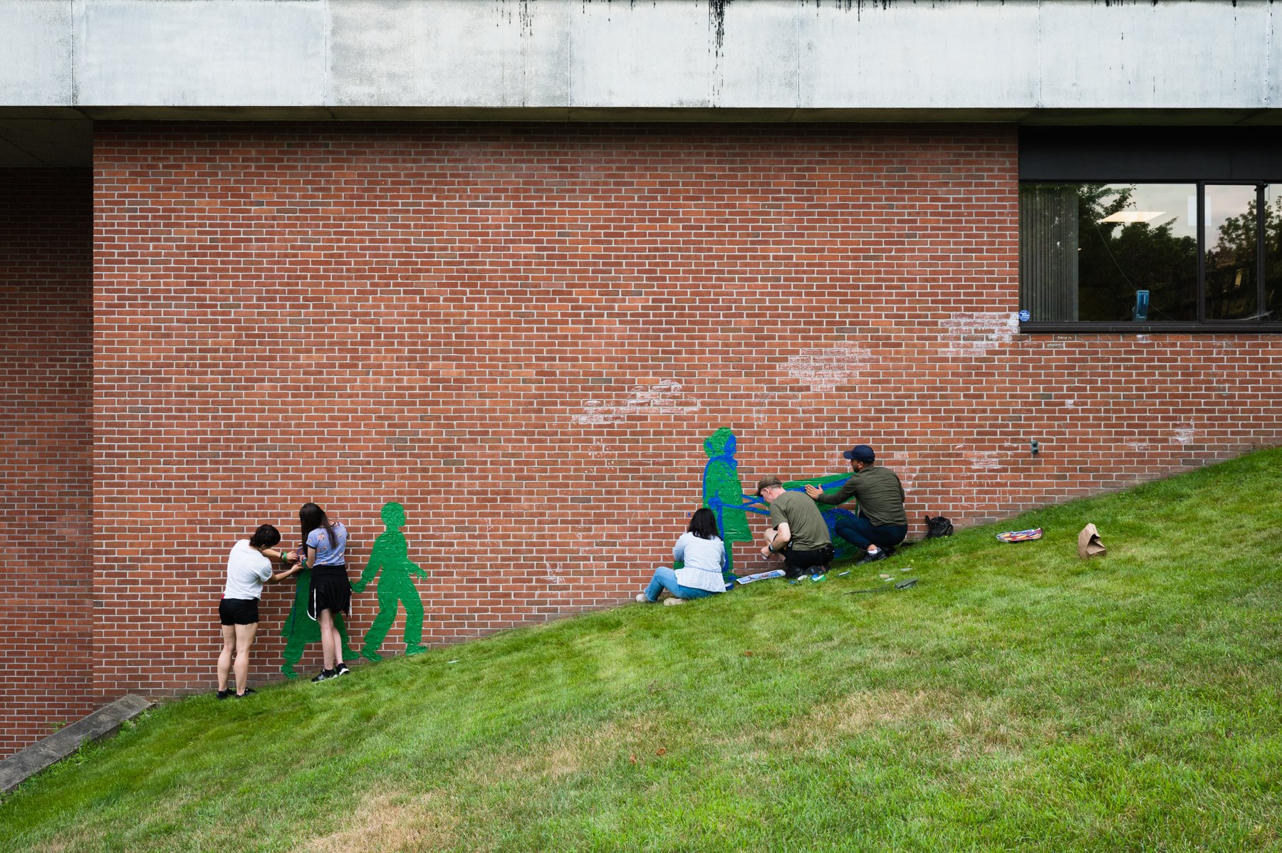A tape-art mural takes shape outside Brattleboro’s Brooks Memorial Library in 2022. The town-wide exhibit was called “Honoring Honar,” which means “honoring art” in the Dari language.