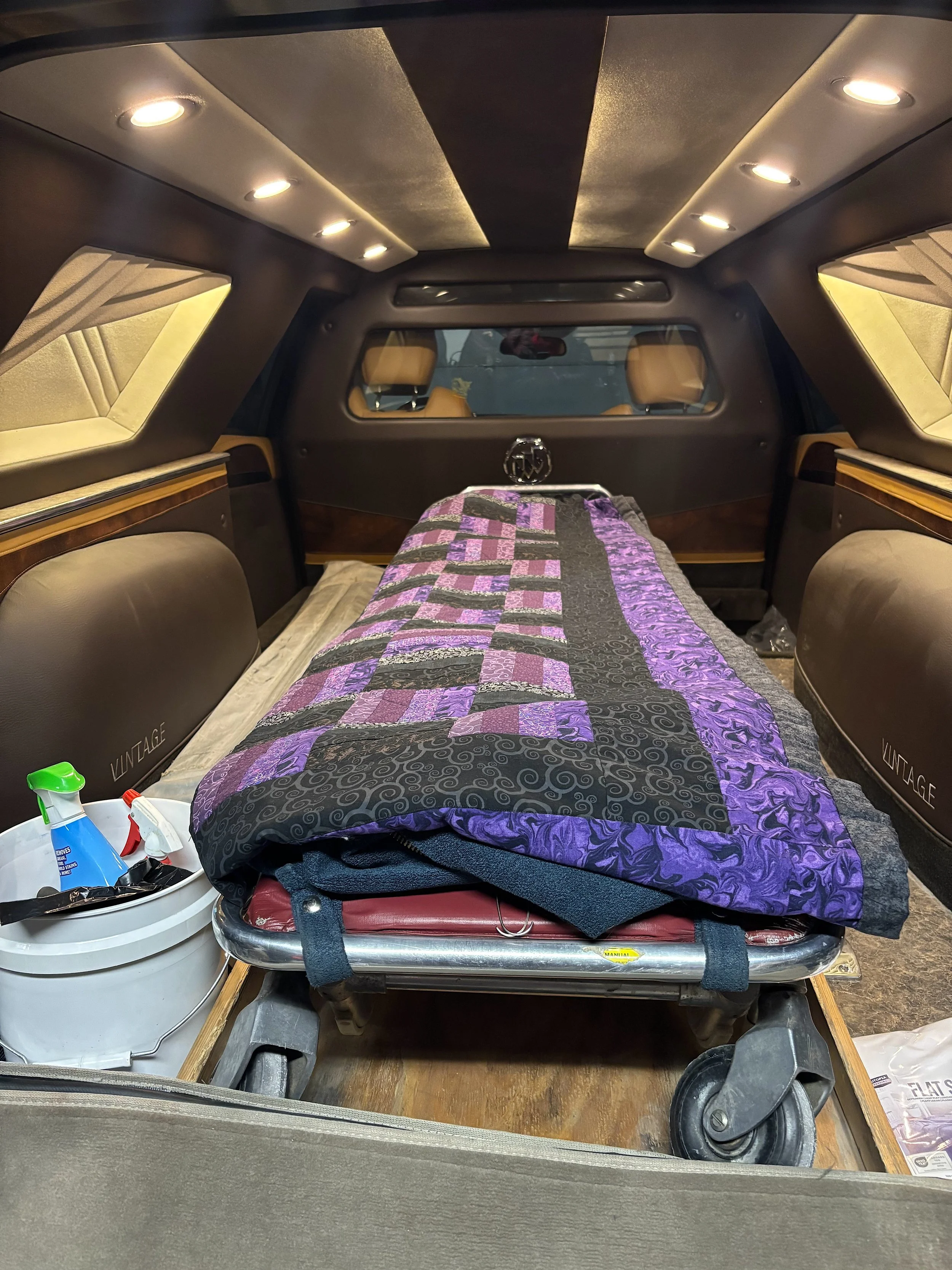 In back of the funeral home's hearse, there's a quilt that Greg's wife made to cover the bodies of the deceased.
