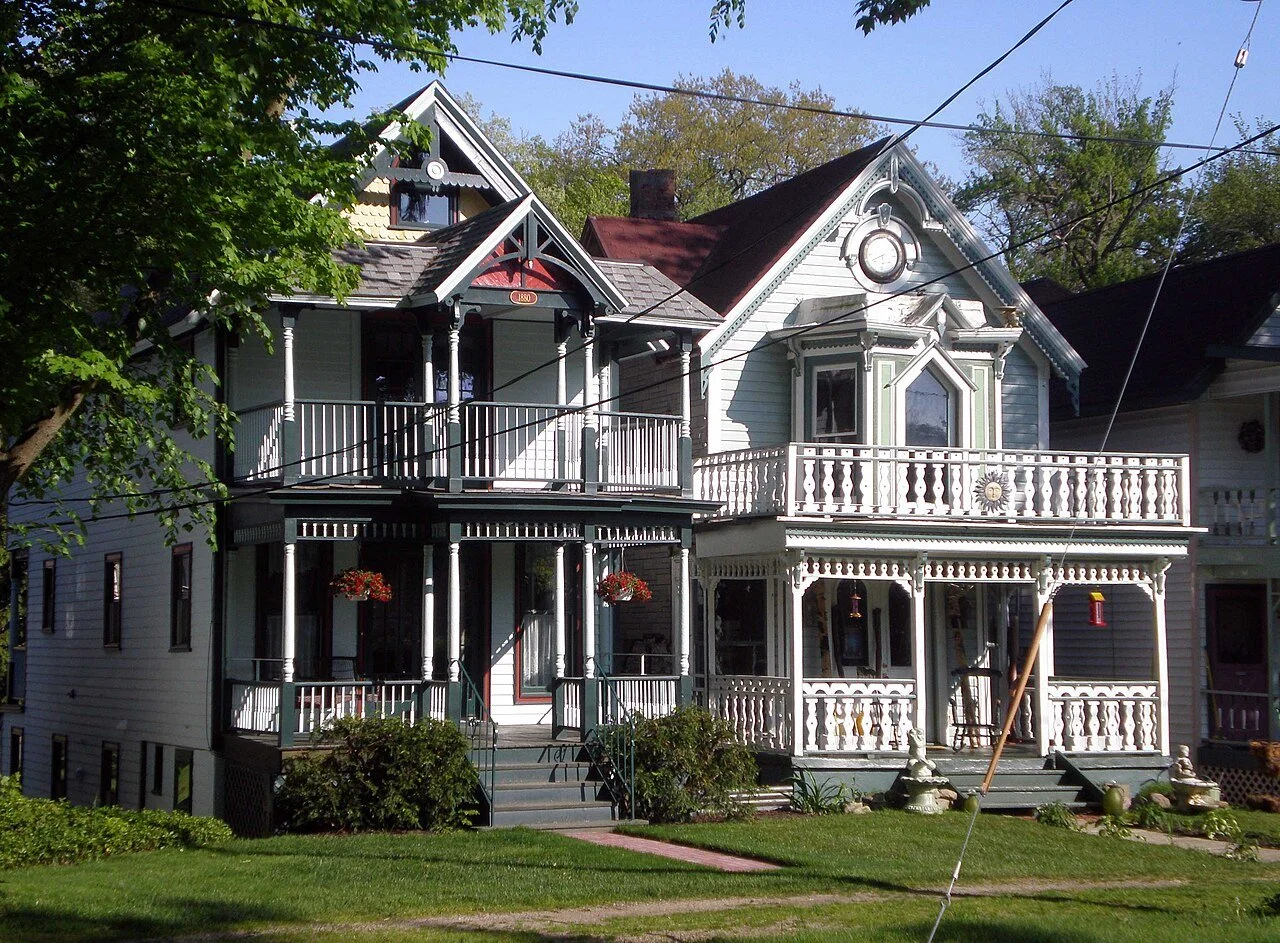 Victorian cottages in Lily Dale, New York, with ornate porches and decorative trim. Many homes in the historic Spiritualist community are used by registered mediums who offer private readings to visitors.