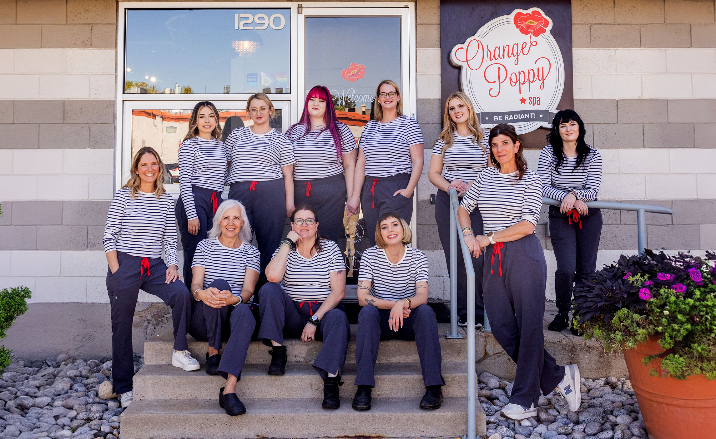 Orange Poppy Spa Team in front of spa.