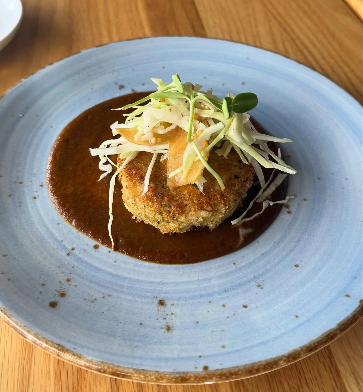 New fall inspired favorite- crab cake, cabbage and apple slaw, kimchi sauce, and pickled mustard seeds. 🍁