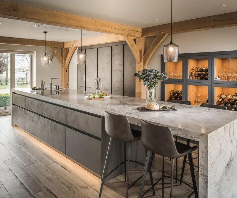 Modern kitchen with marble island, wood beams, pendant lighting, wine storage, and bar seating.