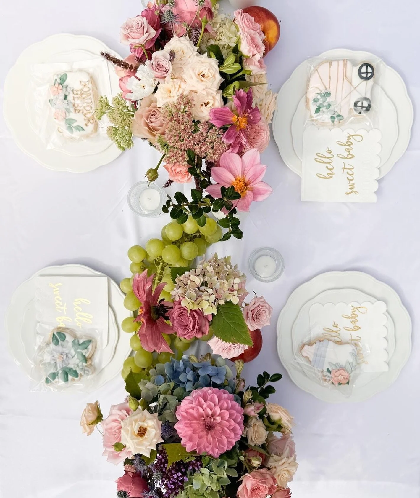 There is something special about bringing people together around a table.
For this gathering, we designed a setting that felt soft, welcoming, and filled with gentle beauty.
Layered florals, fruit, and sweet details came together to create a moment t
